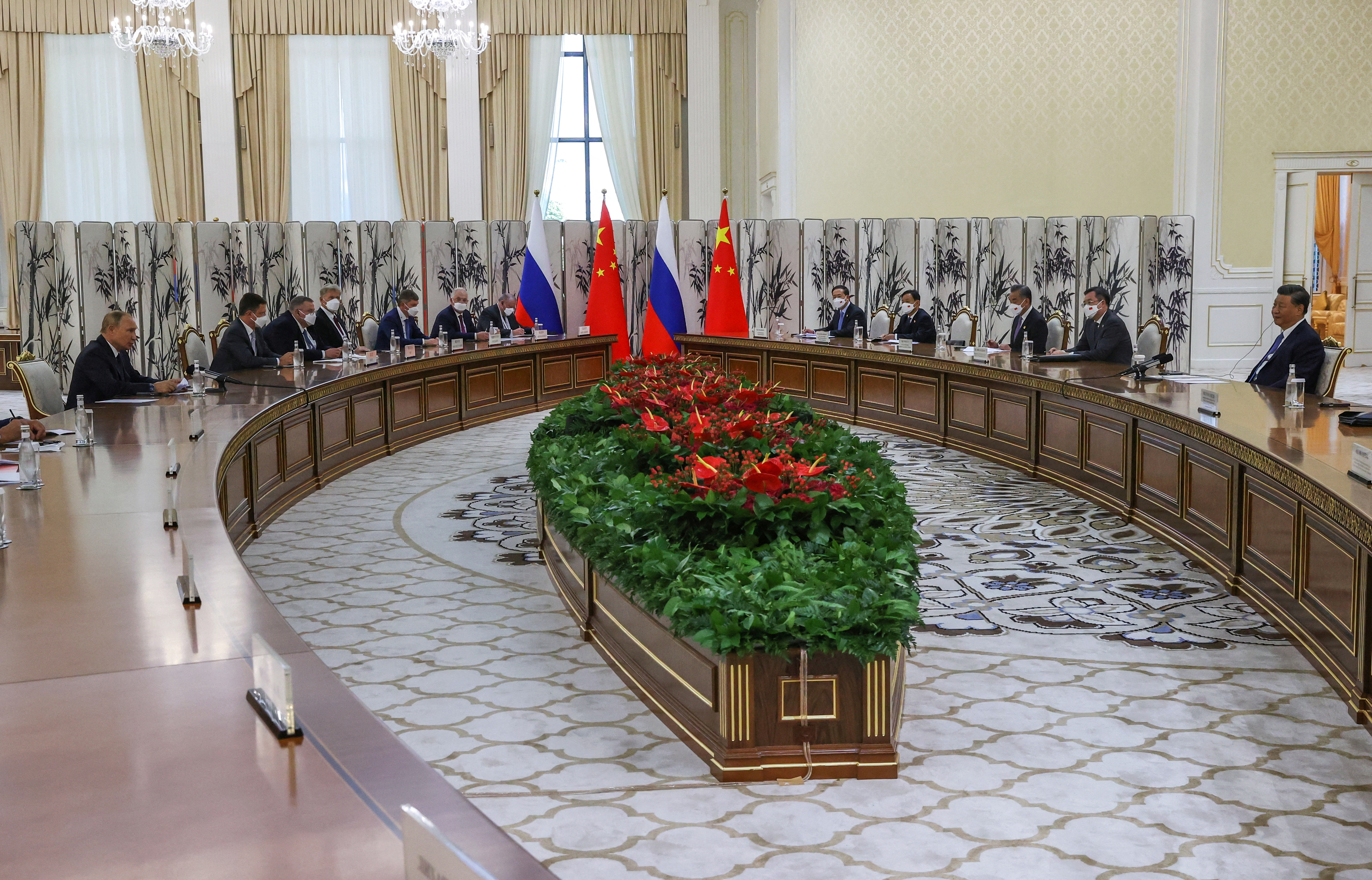 Russian President Vladimir Putin sits opposite Chinese President Xi Jinping during their meeting at the Shanghai Cooperation Organization (SCO) summit in Samarkand, Uzbekistan on September 15, 2022 [Sputnik/Alexandr Demyanchuk/Pool via Reuters]