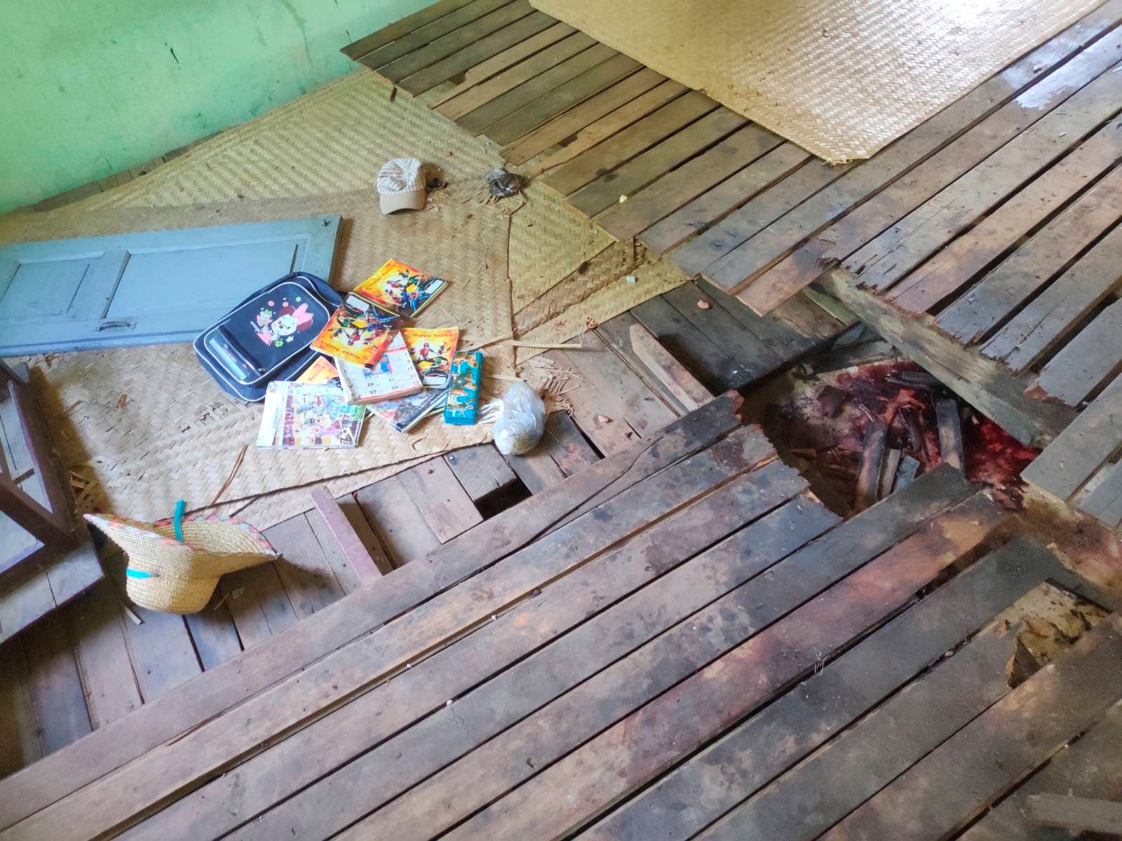 Children's school books scattered across a floor stained with blood at a school in Myanmar's Sagaing region that was attacked by army helicopters.