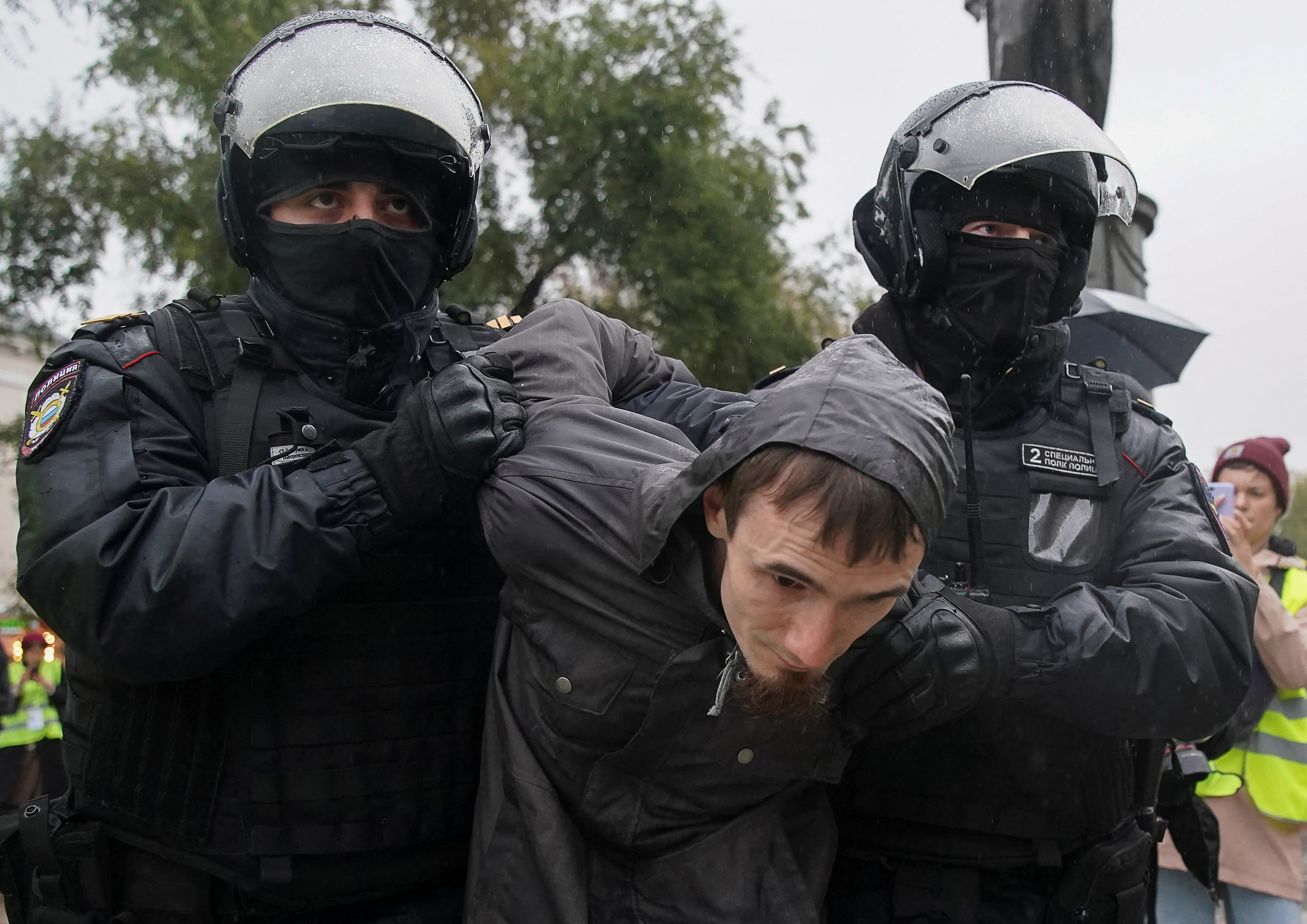 Russian law enforcement officers detain a person during a rally, after opposition activists called for street protests against the mobilisation of reservists.