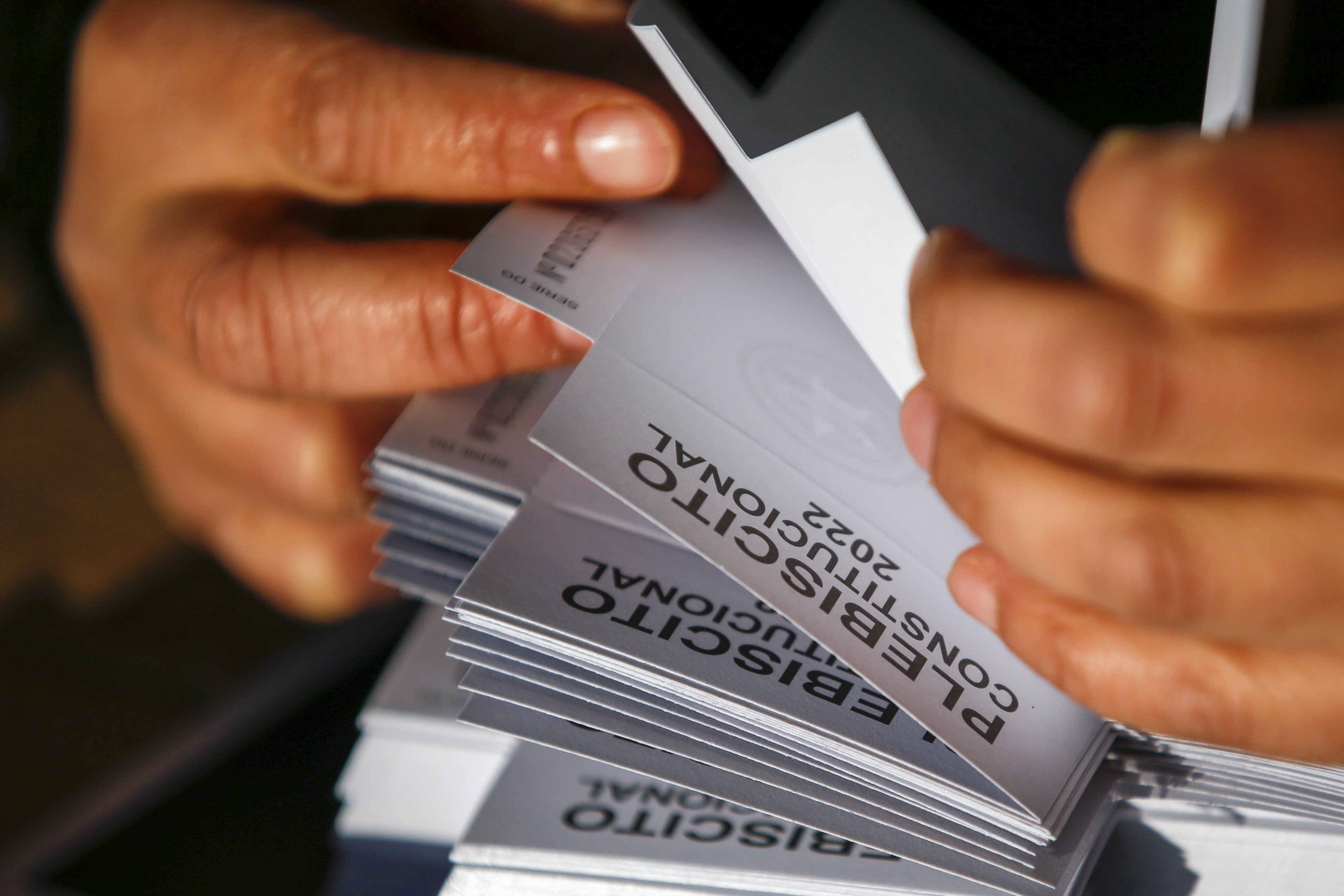 A close up picture of an election worker counting the referendum votes