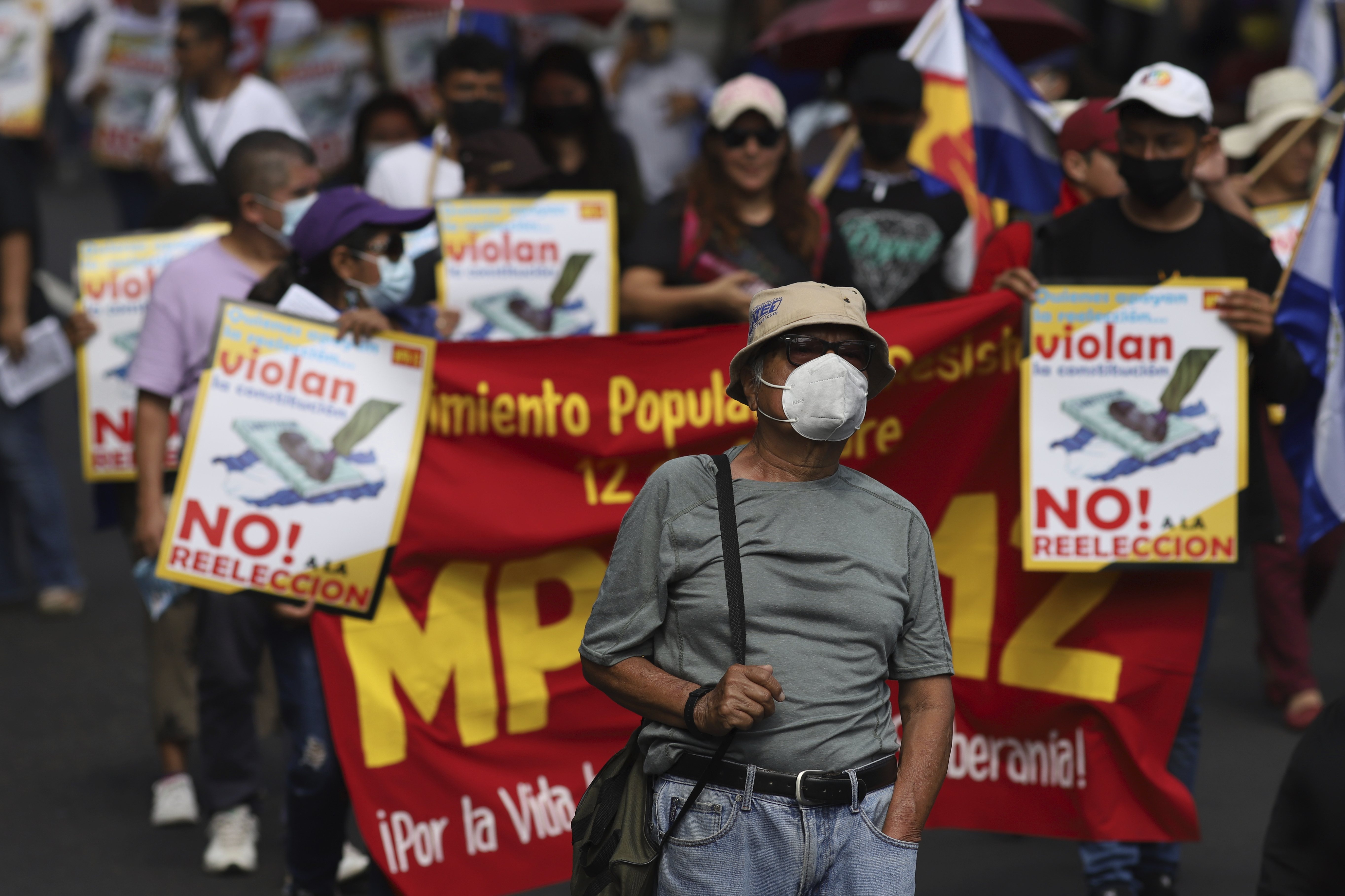 Anti-government protestors hold banners as they march