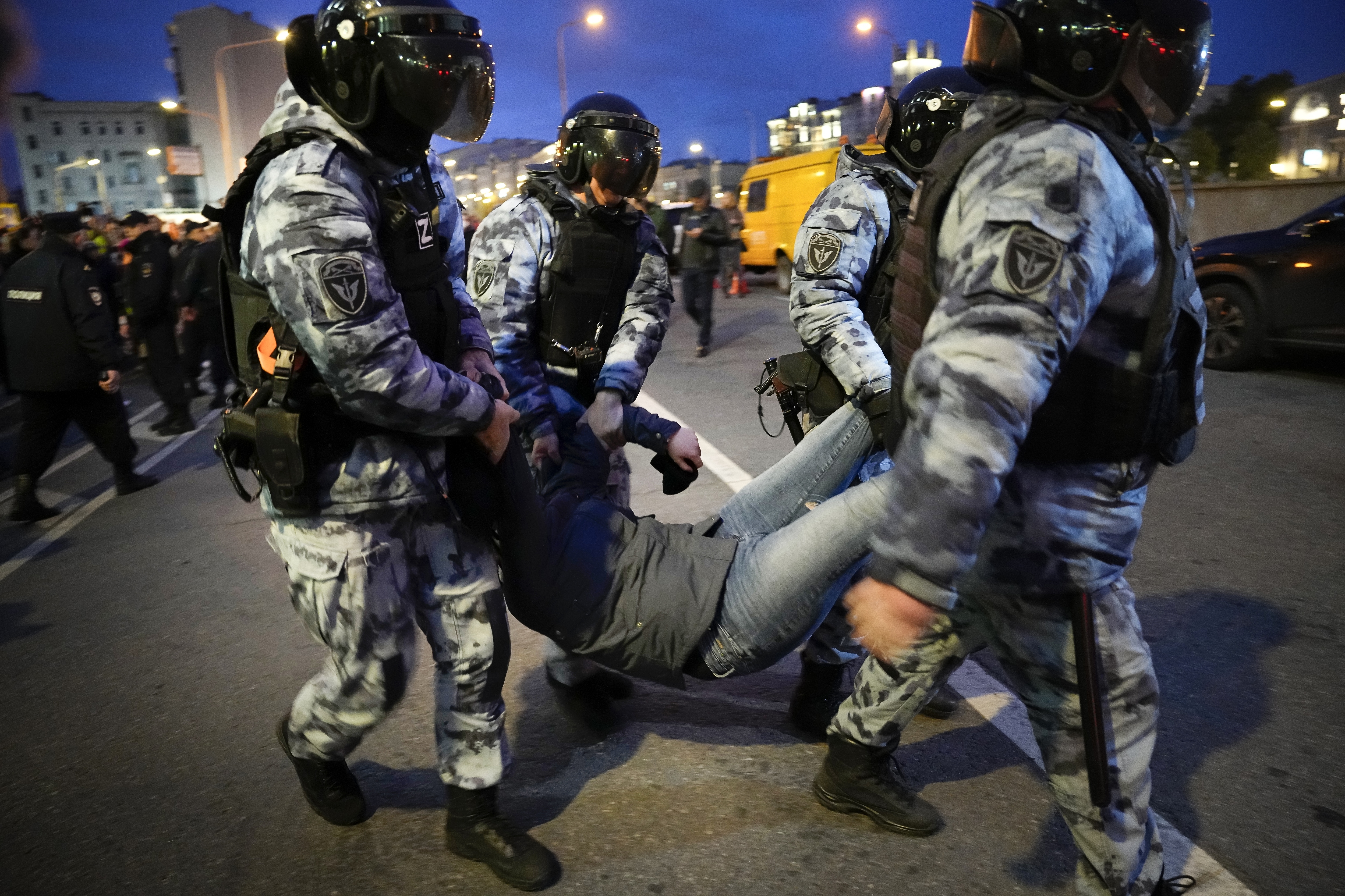 Riot police carry away a demonstrator during a protest against mobilization in Moscow, Russia.