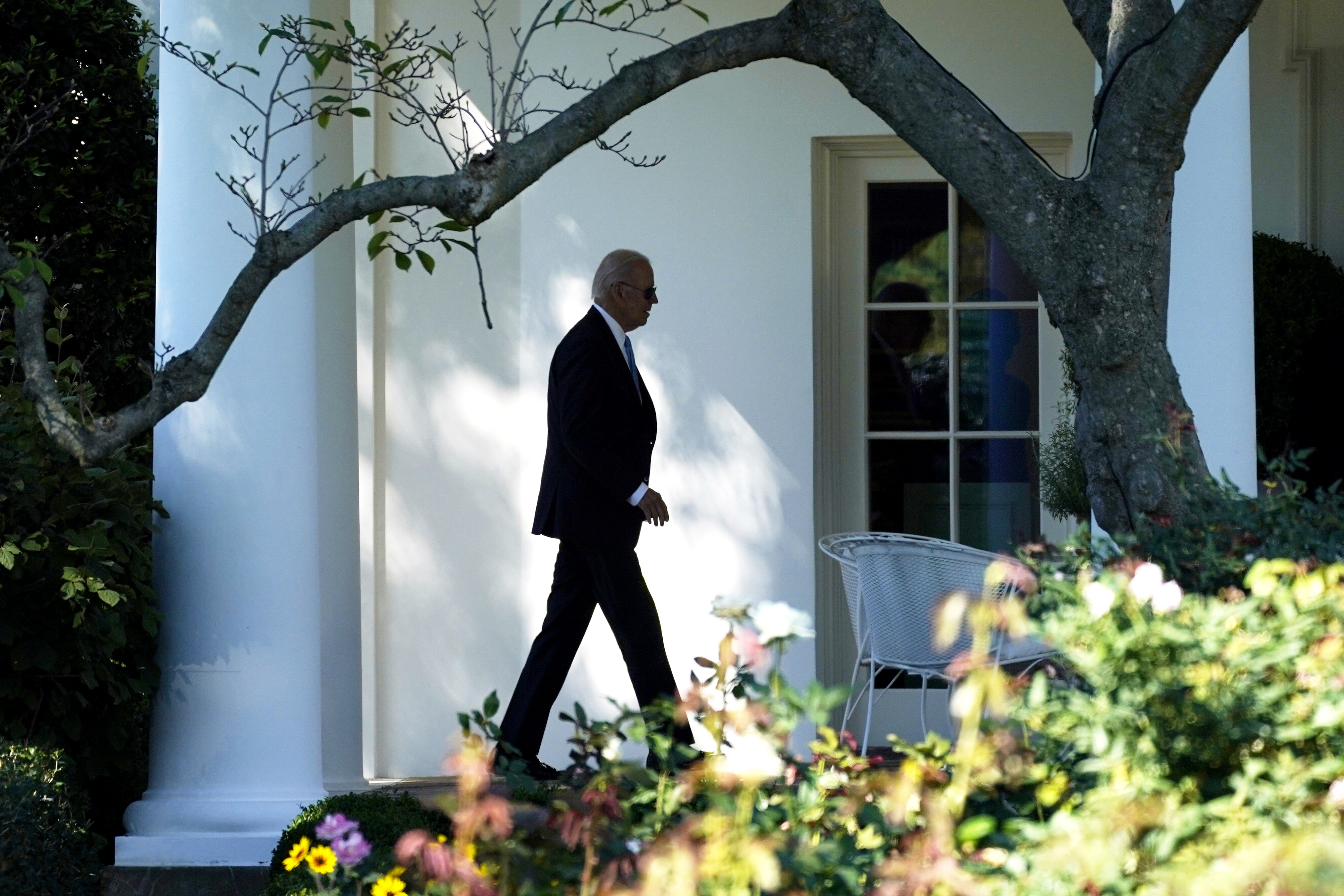 US president Joe Biden walking outside the White House