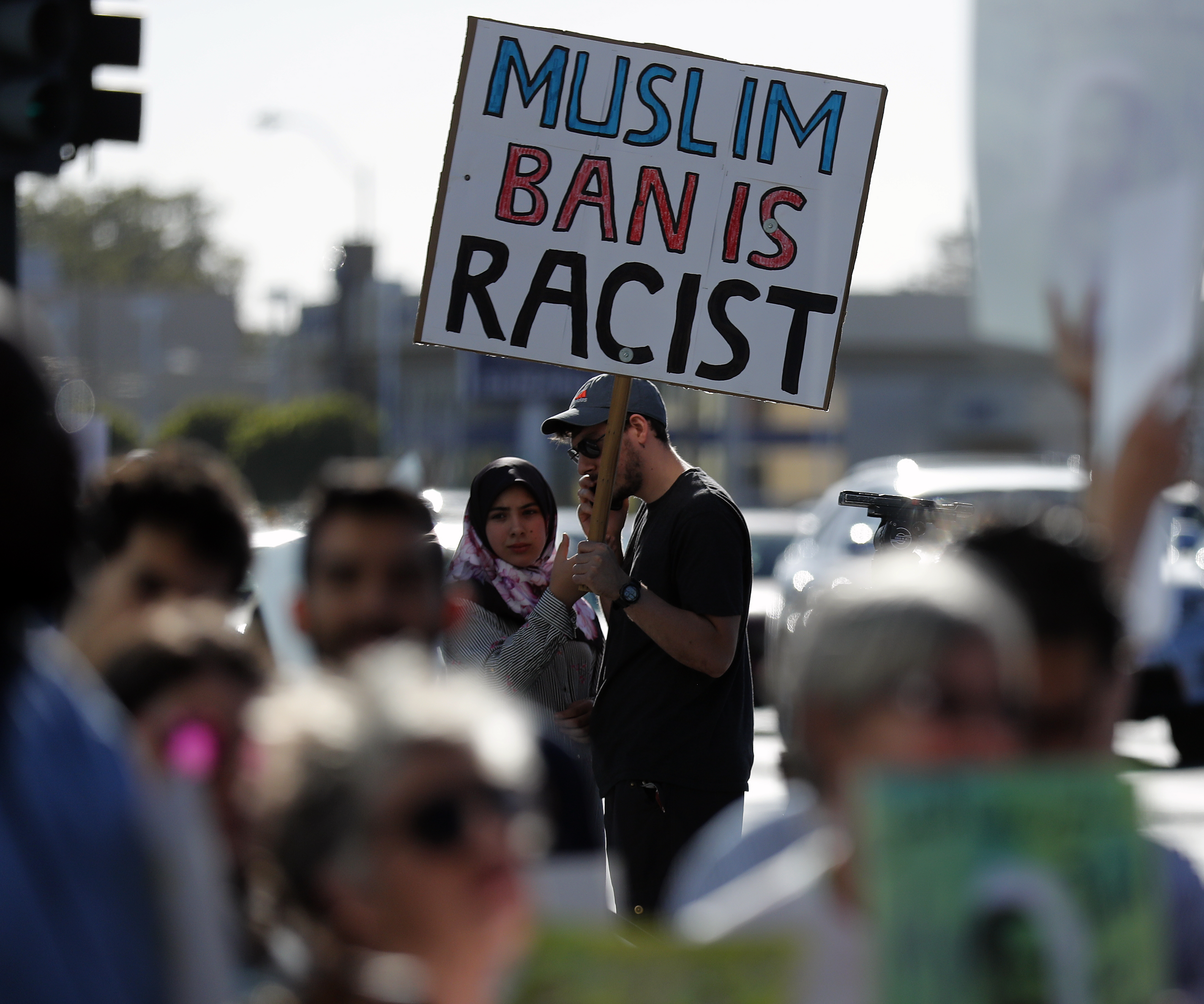People demonstrate against a ruling by the US Supreme Court upholding President Trump's travel ban on people from mostly Muslim countries