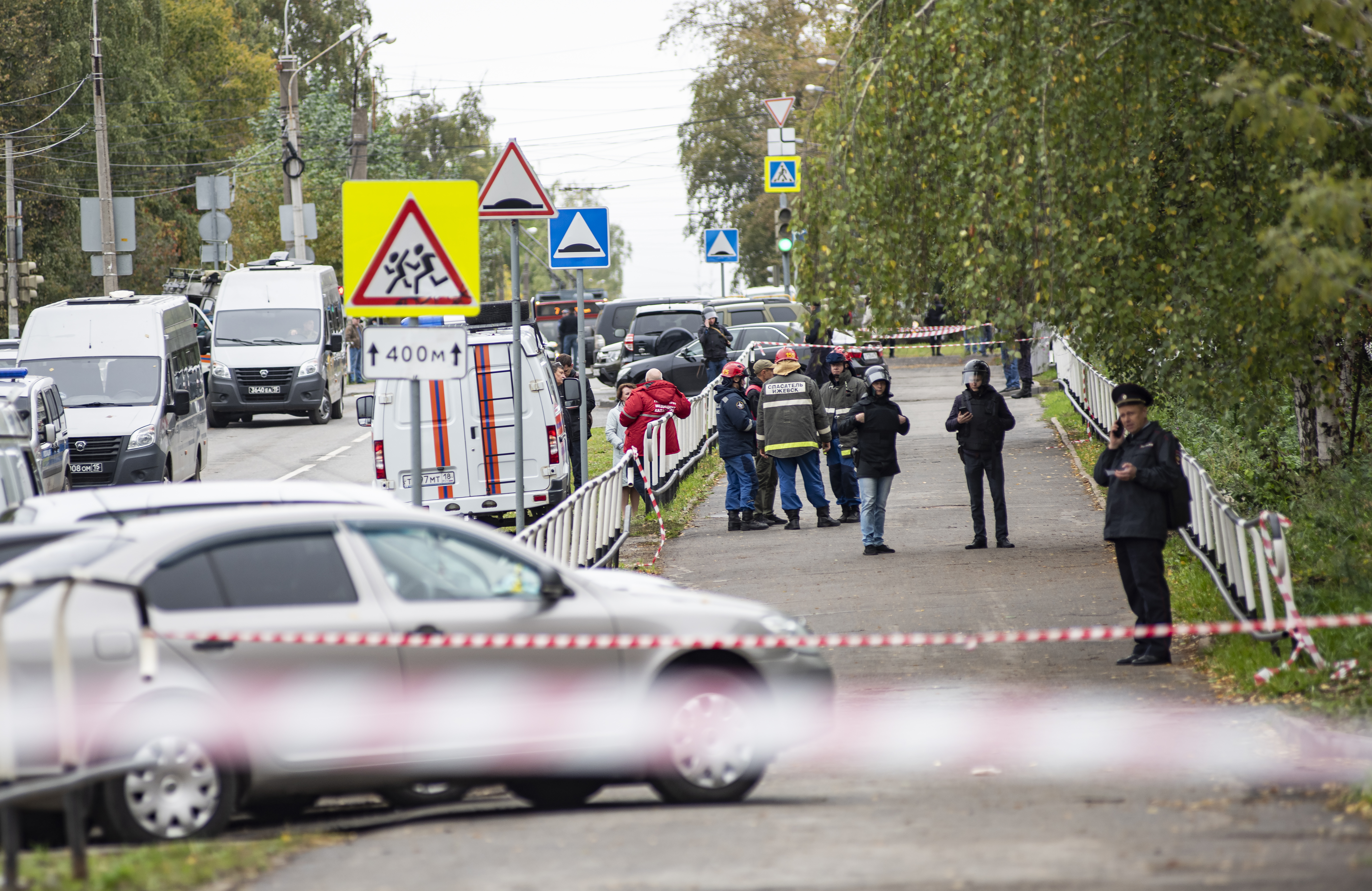 Russian policemen and emergency services members work near the scene of a school shooting.