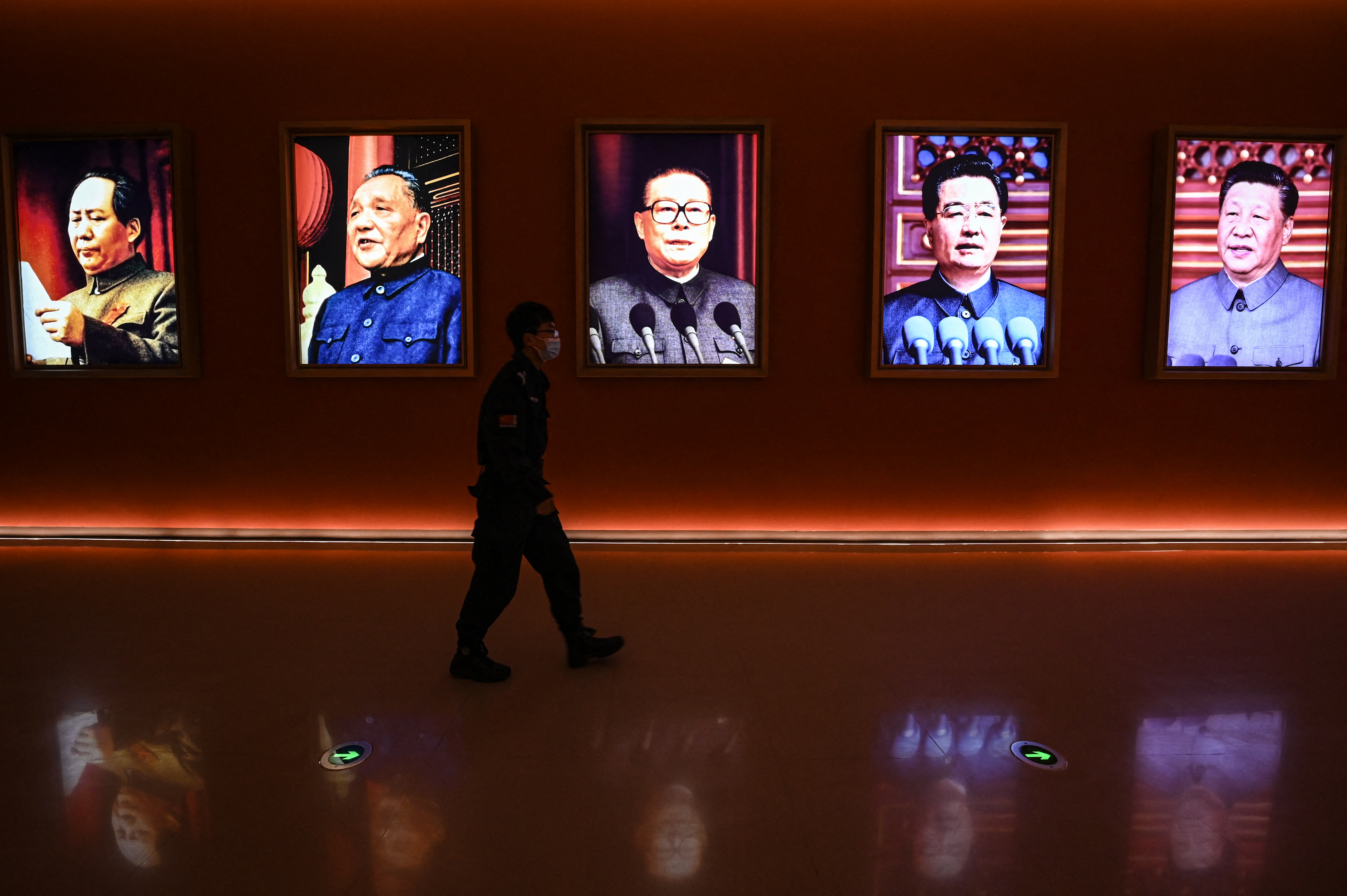 A man walks past portraits of late Chinese chairman Mao Zedong and former Chinese leaders Deng Xiaoping, Jiang Zemin, Hu Jintao and current president Xi Jinping at Yan'an Revolutionary Memorial Hall in Yan'an city, China.