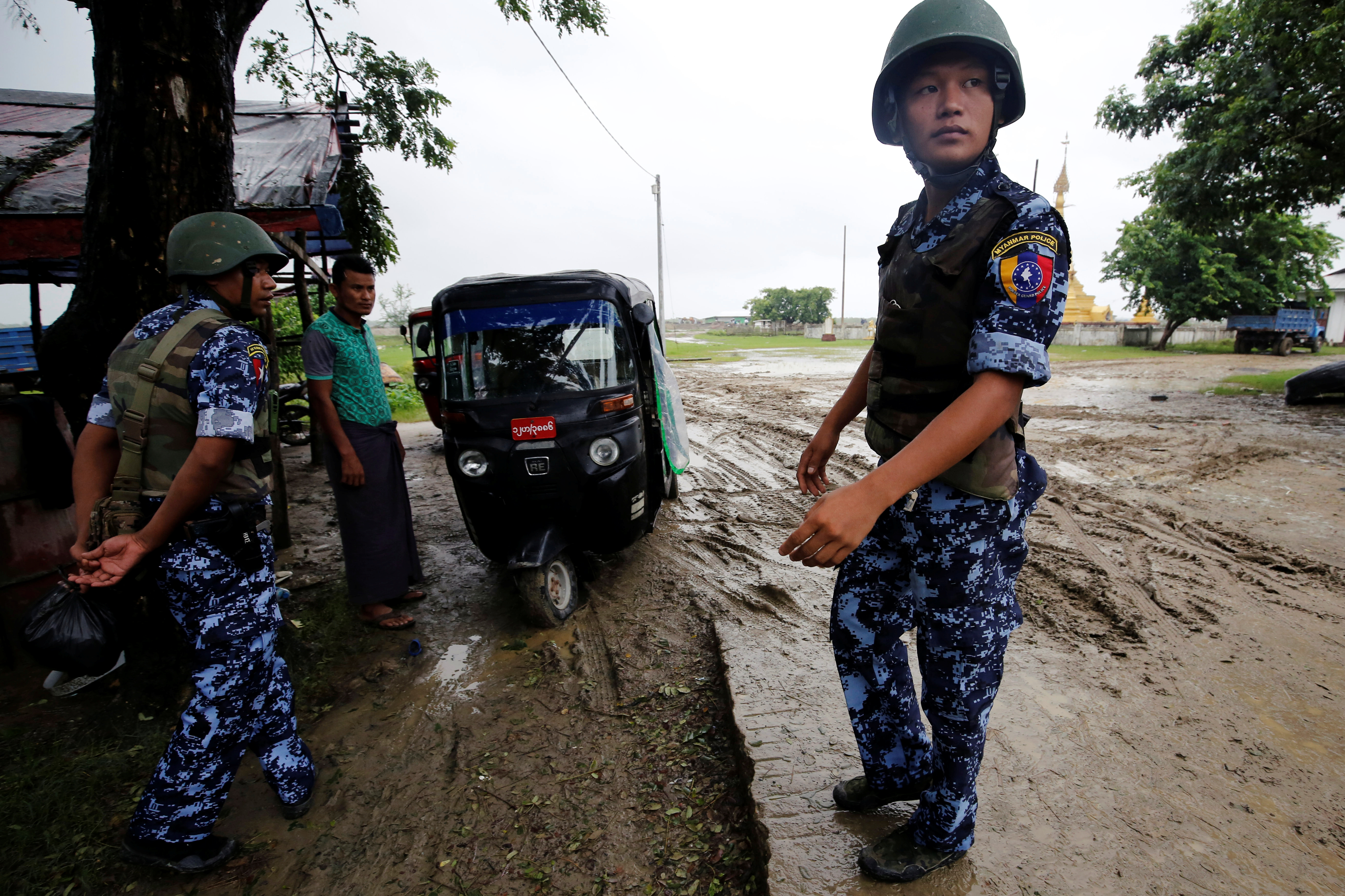 An armed Myanmar police officer standing guard on the street in Maungdaw, Rakhine state.