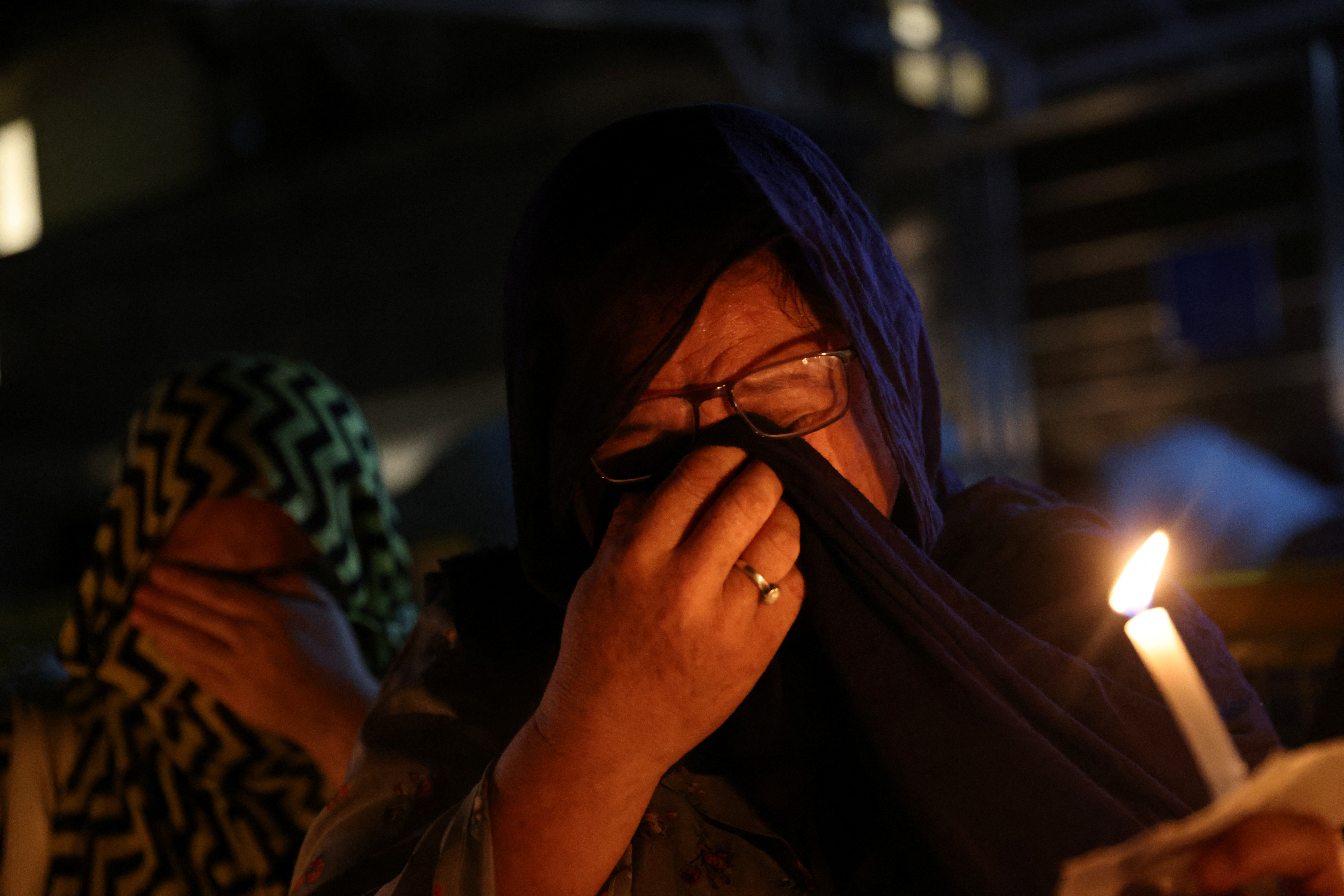 An Afghan national, member of the Hazara minority, breaks down at a protest against the suicide attack at a tutoring center in west Kabul, outside the United Nations High Commissioner for Refugees (UNHCR) office, in New Delhi, India, September 30, 2022. REUTERS/Anushree Fadnavis