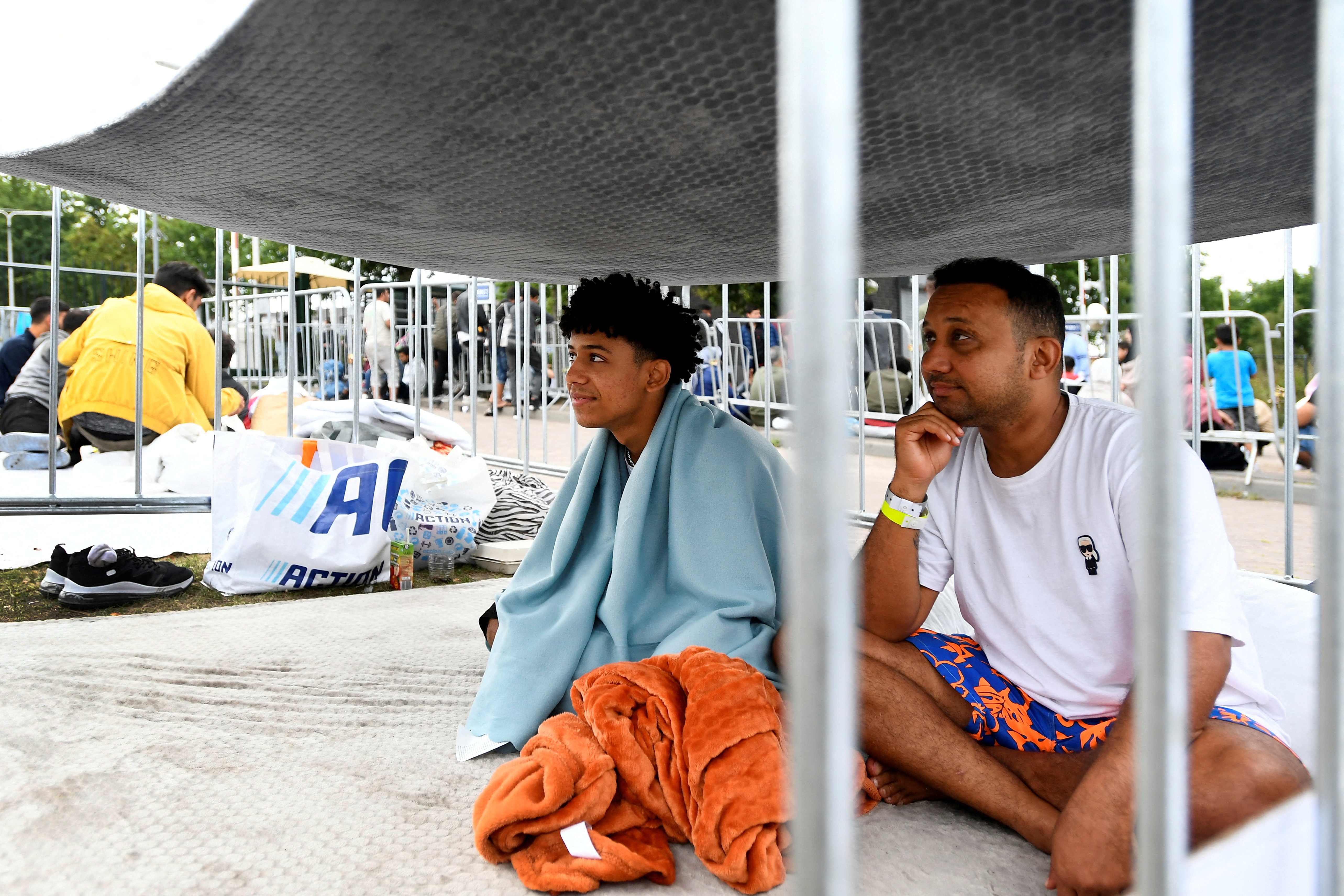FILE PHOTO: Refugees wait outside at the main reception centre for asylum seekers, in Ter Apel, Netherlands August 26, 2022. REUTERS/Piroschka van de Wouw/File Photo