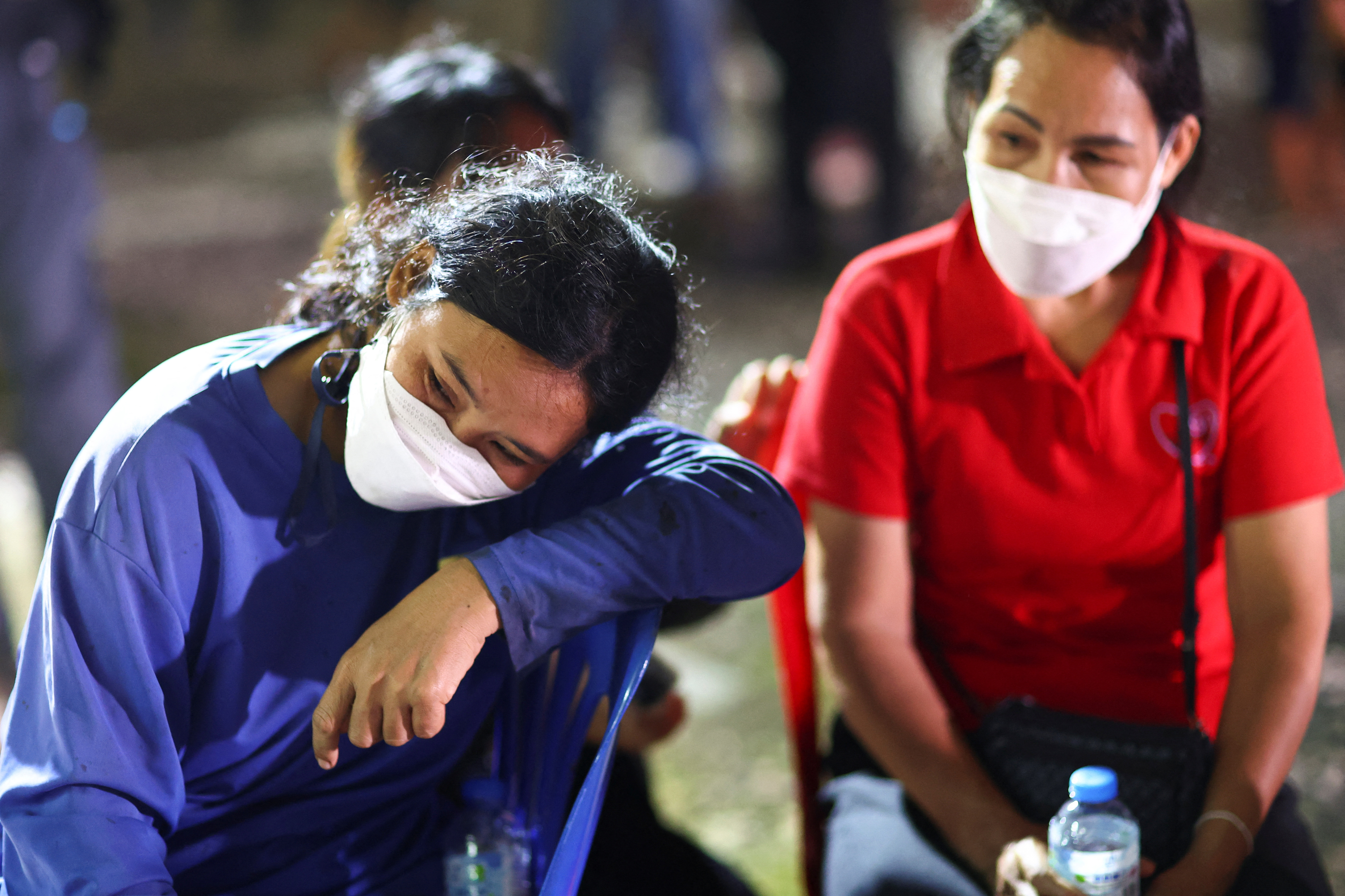 People gather outside a day care center which was the scene of a mass shooting, in the town of Uthai Sawan, around 500 km northeast of Bangkok