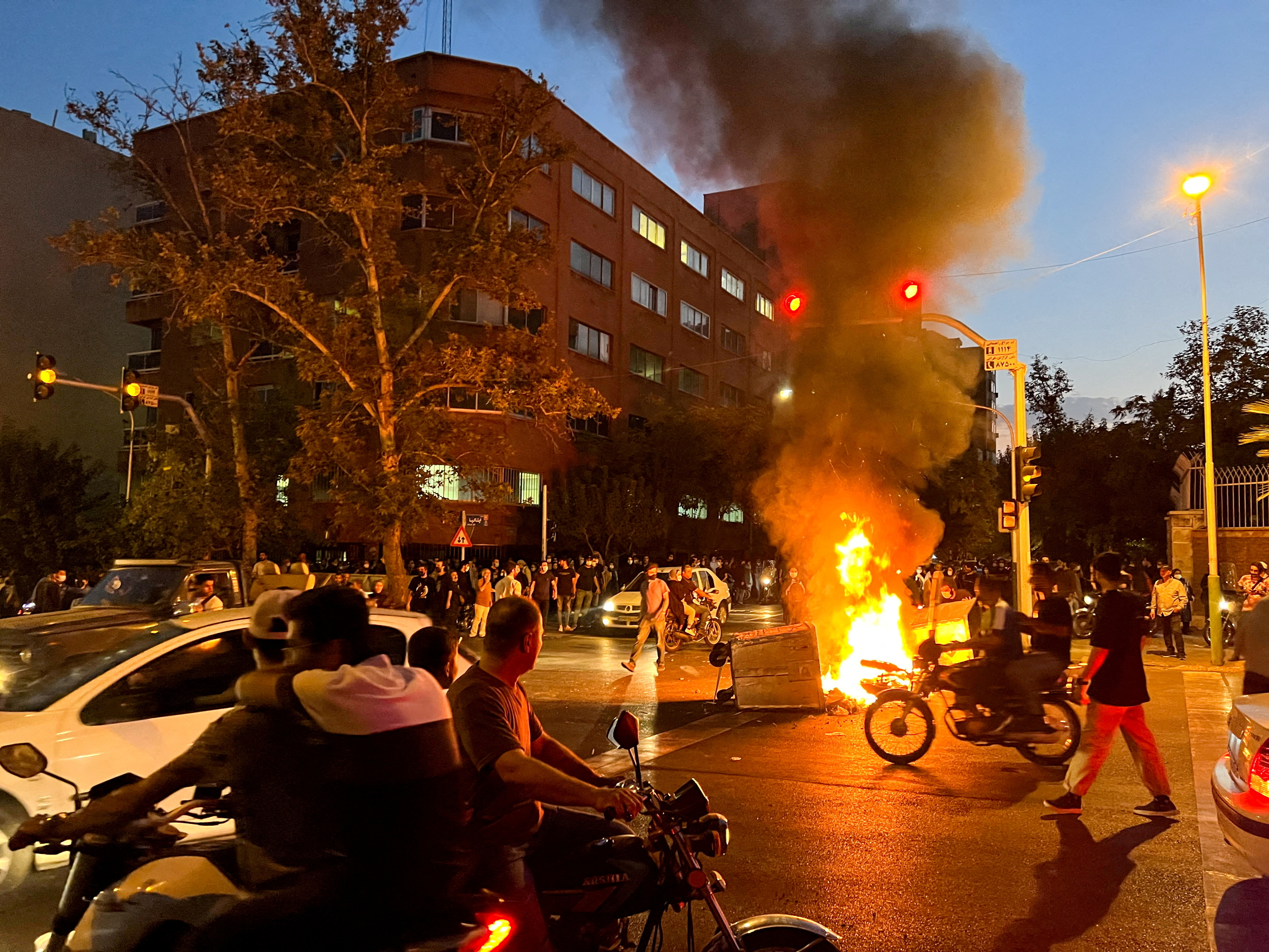 A police motorcycle burns during a protest over the death of Mahsa Amini, a woman who died after being arrested by the Islamic republic's "morality police", in Tehran, Iran September 19, 2022. WANA (West Asia News Agency) via REUTERS//File Photo