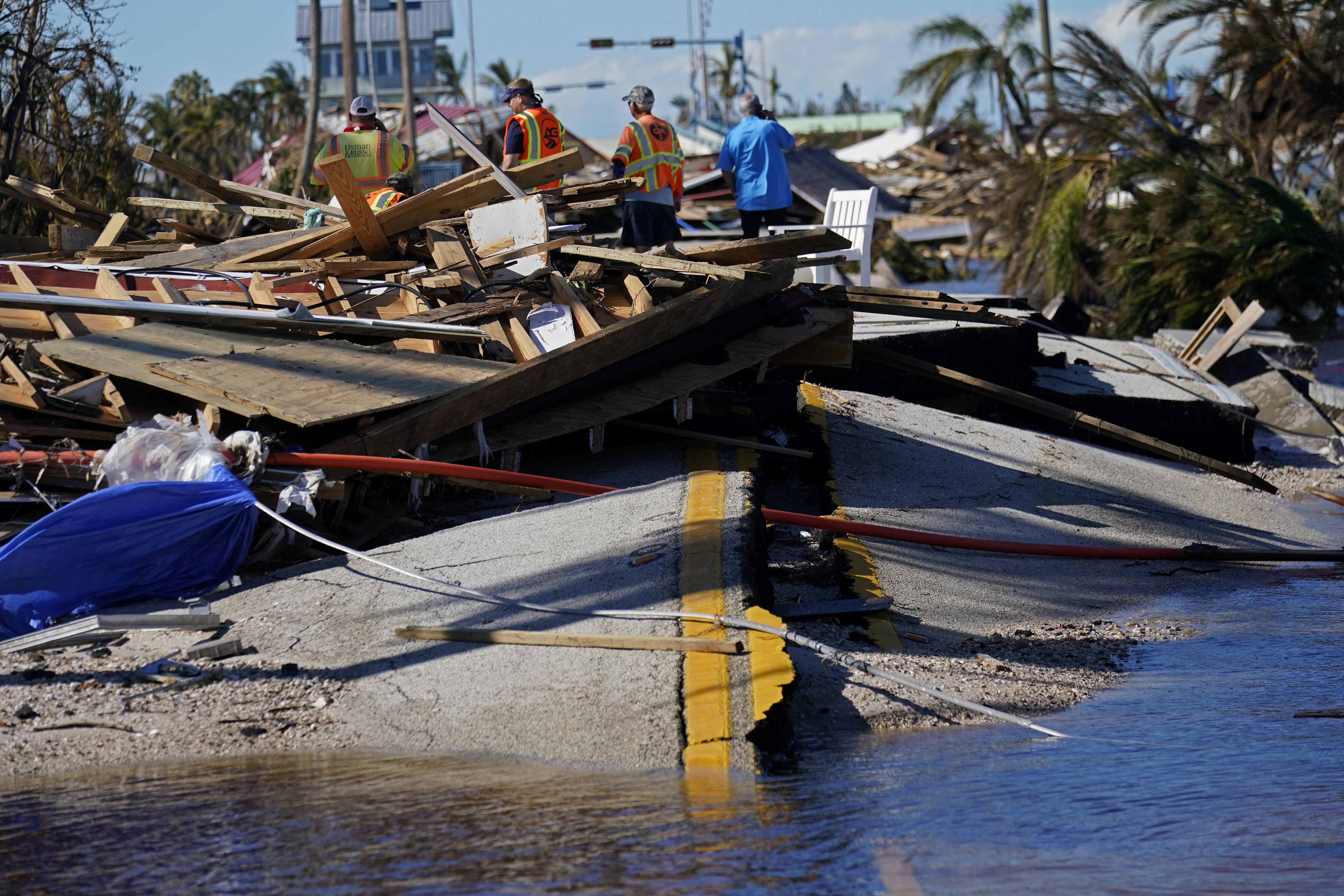 Responders from the de Moya Group survey damage to the bridge leading to Pine Island, to start building temporary access to the island in the aftermath of Hurricane Ian in Matlacha
