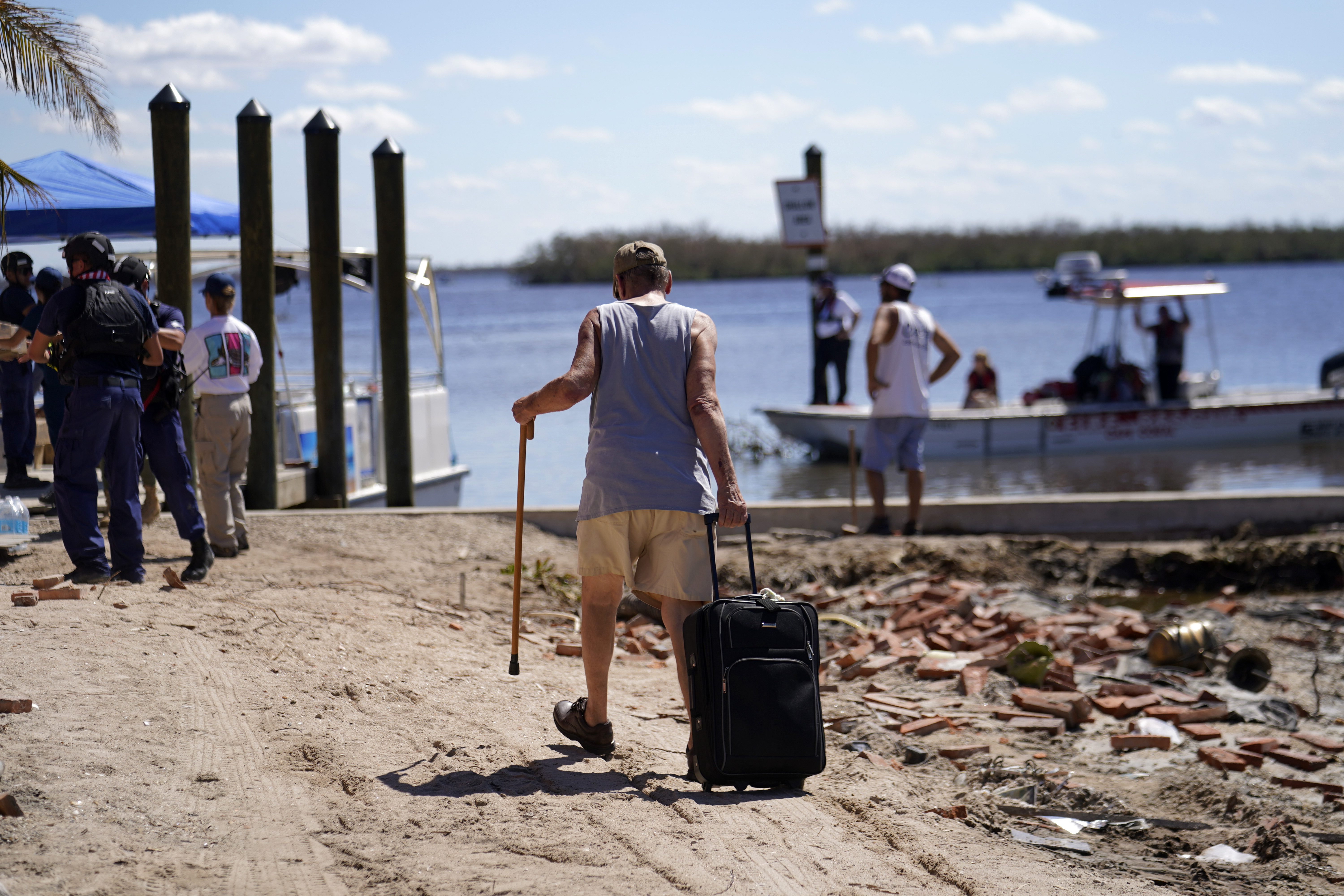 Residents who rode out the storm arrive at a dock to evacuate by boat in the aftermath of Hurricane Ian, on Pine Island in Florida's Lee County