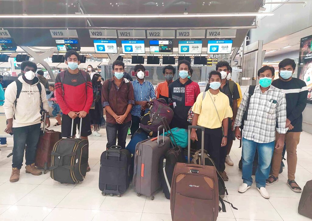 Rescued Indian workers at the airport in India with their bags