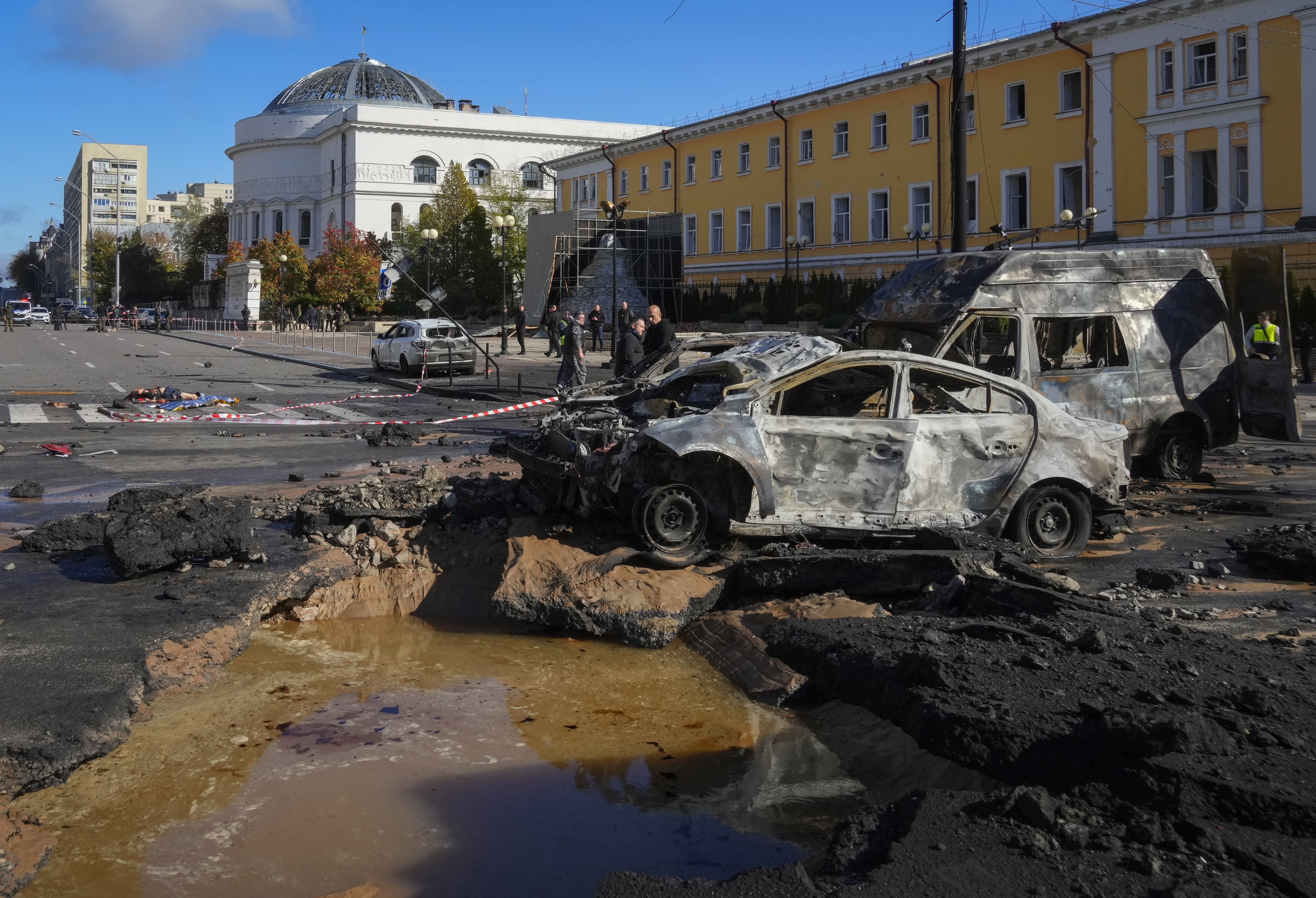 Police inspect the scene of Russian shelling in Kyiv, Ukraine, Monday, Oct. 10, 2022.