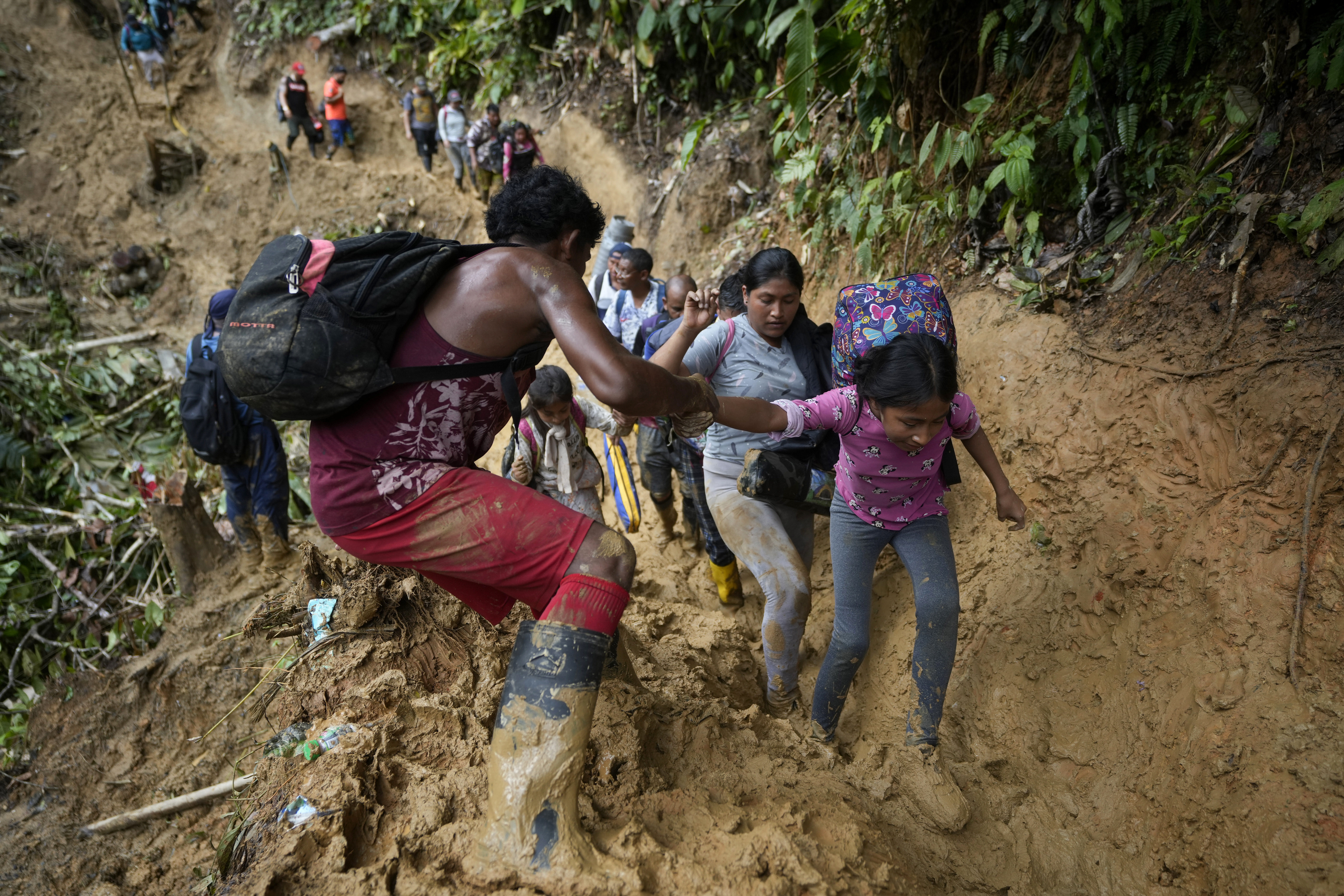 Migrants, mostly Venezuelans, walk across the Darien Gap from Colombia into Panama hoping to reach the U.S. on Saturday, Oct. 15, 2022. (AP Photo/Fernando Vergara)