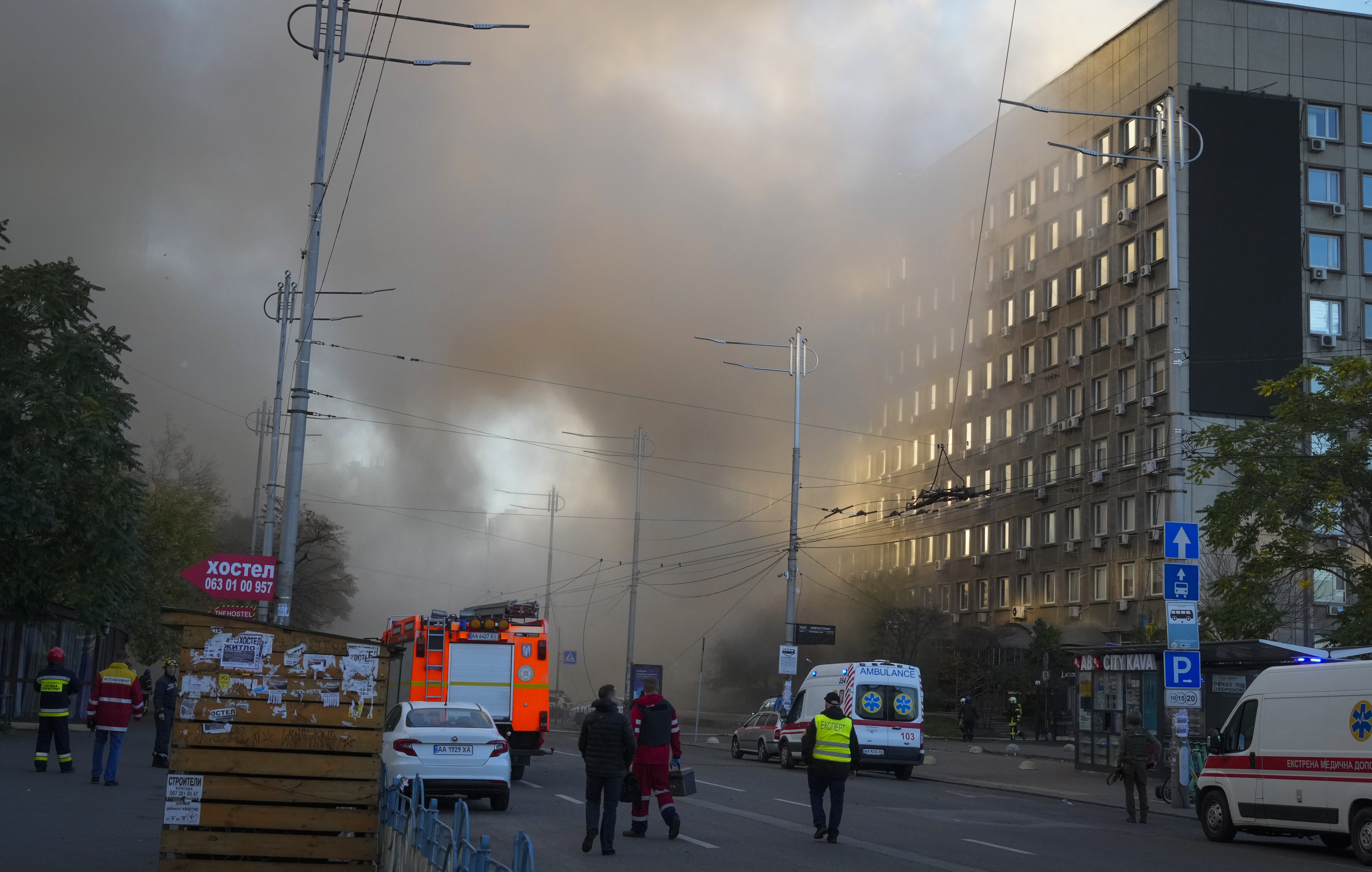Smoke rises from a street in Kyiv as rescuers reach the scene.