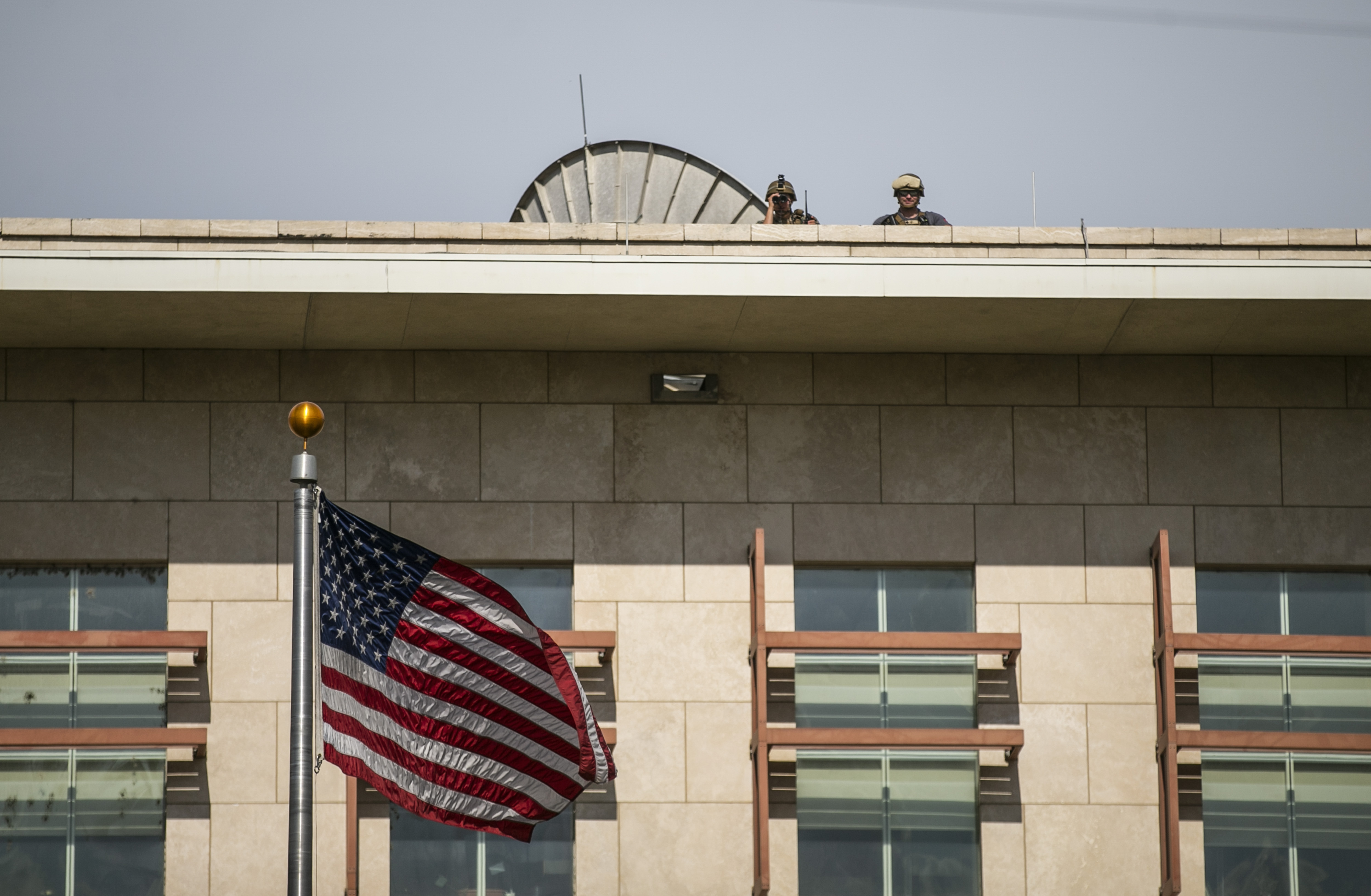 US soldiers stand guard on the roof of the US Embassy as they watch a protest to reject an international military force requested by the government and to demand the resignation of Prime Minister Ariel Henry, in Port-au-Prince, Haiti, Monday, Oct. 17, 2022