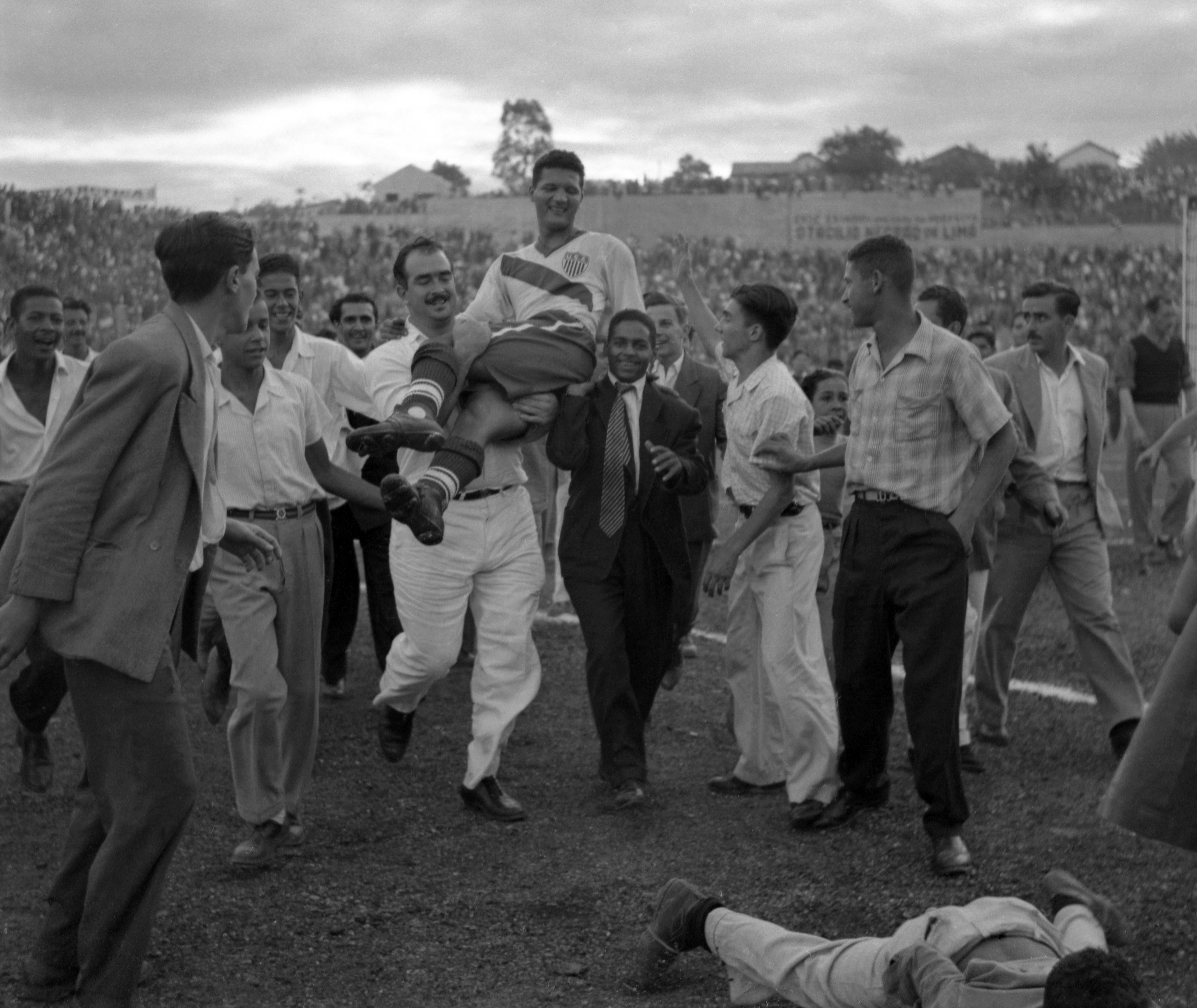 U.S. center forward Joe Gaetjens is carried off by cheering fans after his team beat England 1-0 in the World Cup.