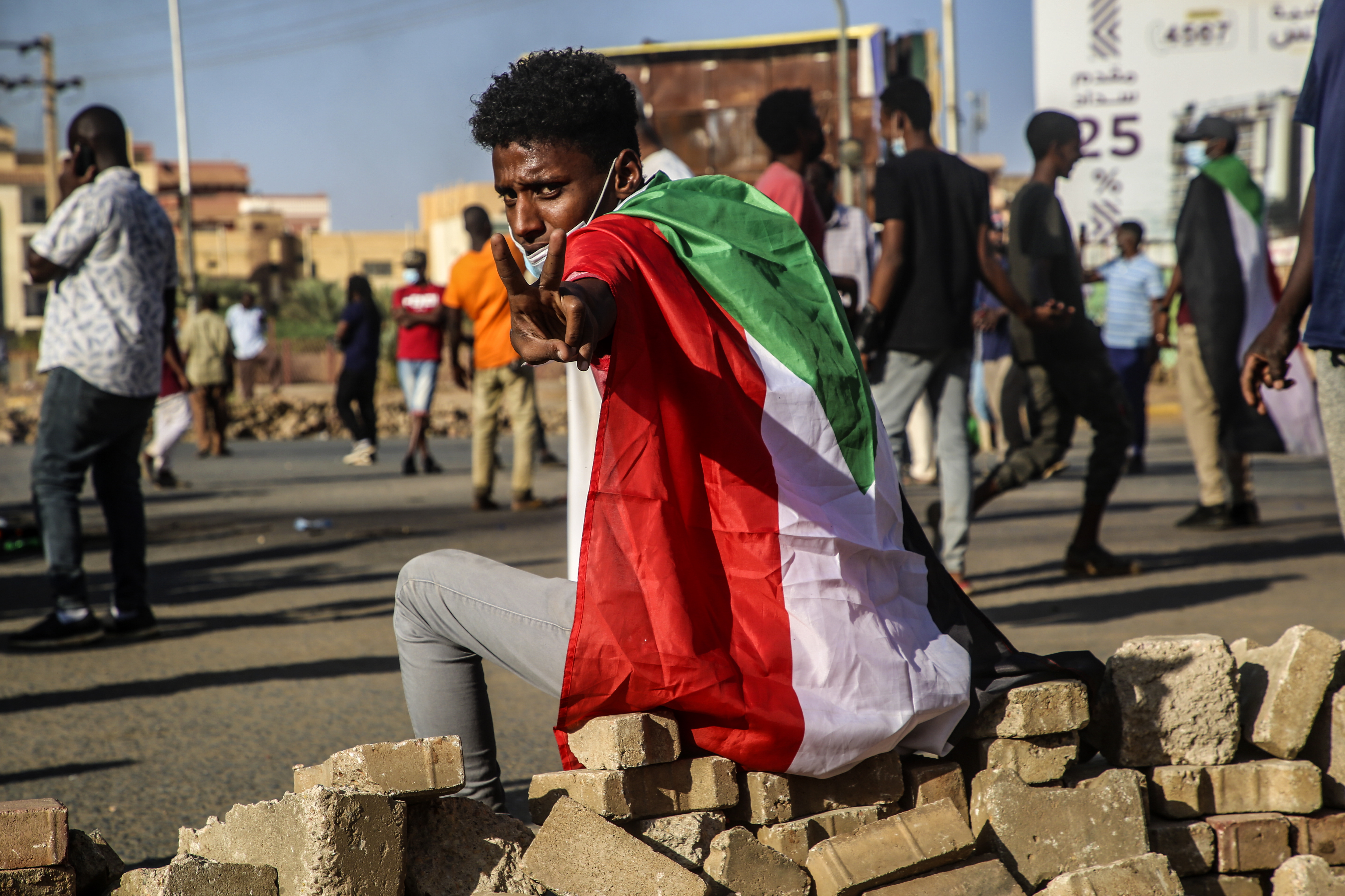 epa09580354 A Sudanese protester flashes the victory sign during a protest against the military coup in Khartoum, Sudan, 13 November 2021. According to medics, three anti-coup protesters were killed during protests in which security forces reportedly used tear gas to disperse the demonstrators gathering two days after the formation of a new Sovereign Council to rule the country. Sudan's military seized power on 25 October and arrested the Prime Minister and other senior ministers and civilian members of the Transitional Sovereignty Council during early morning raids. EPA-EFE/STRINGER
