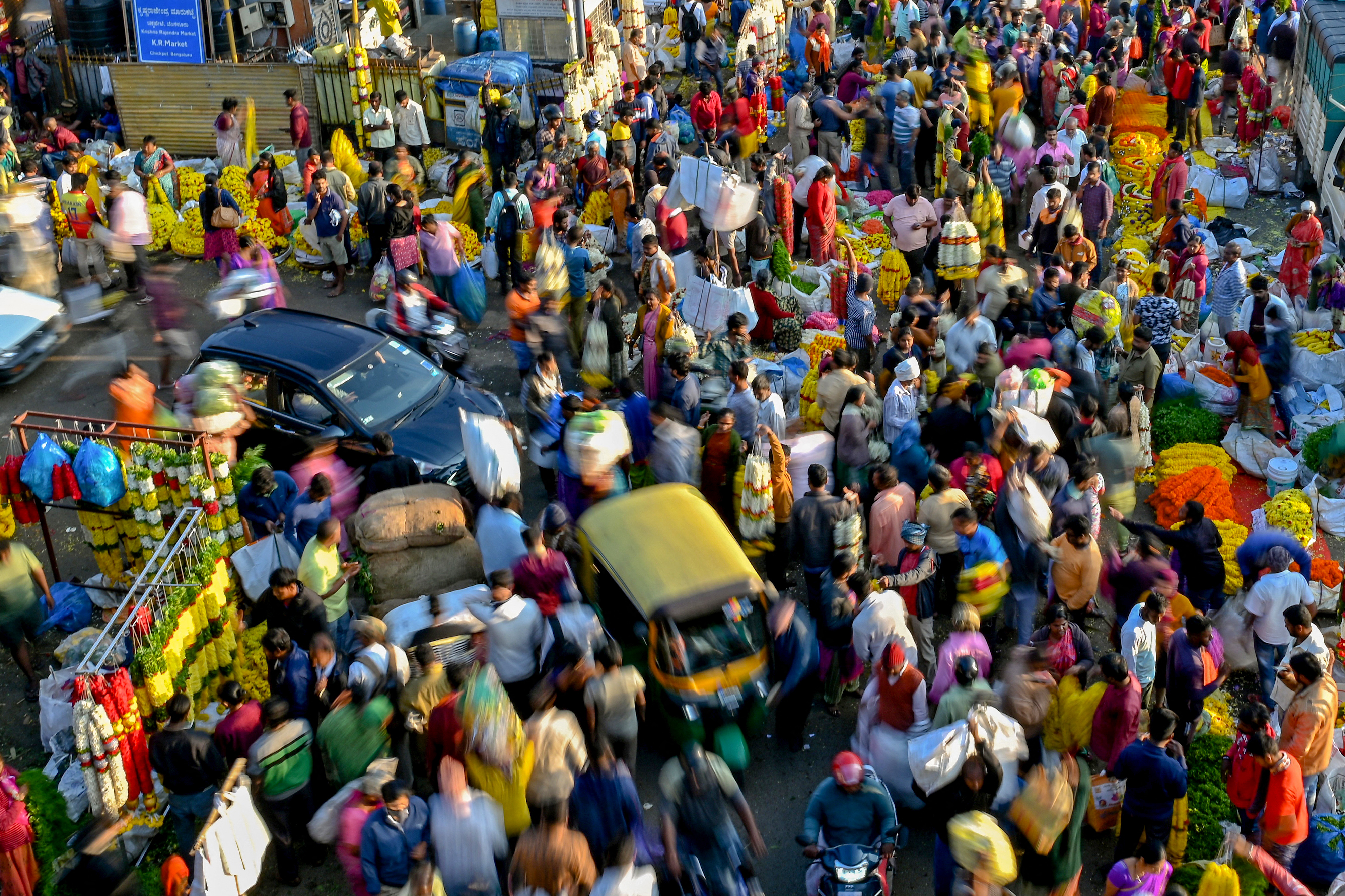 people walking through a market in Bangalore