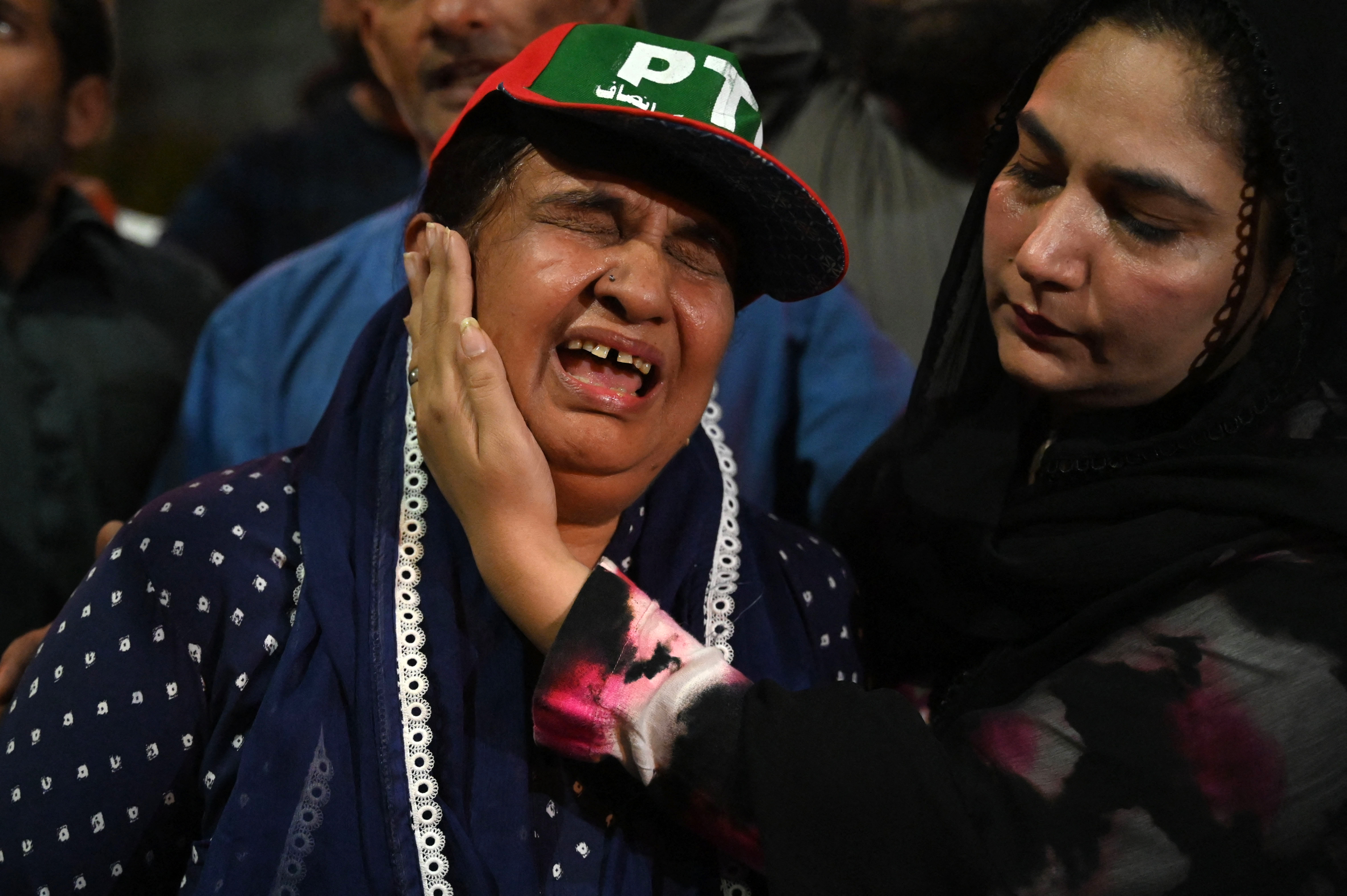 Supporters of Pakistan's former prime minister Imran Khan, react during a protest against the assassination attempt