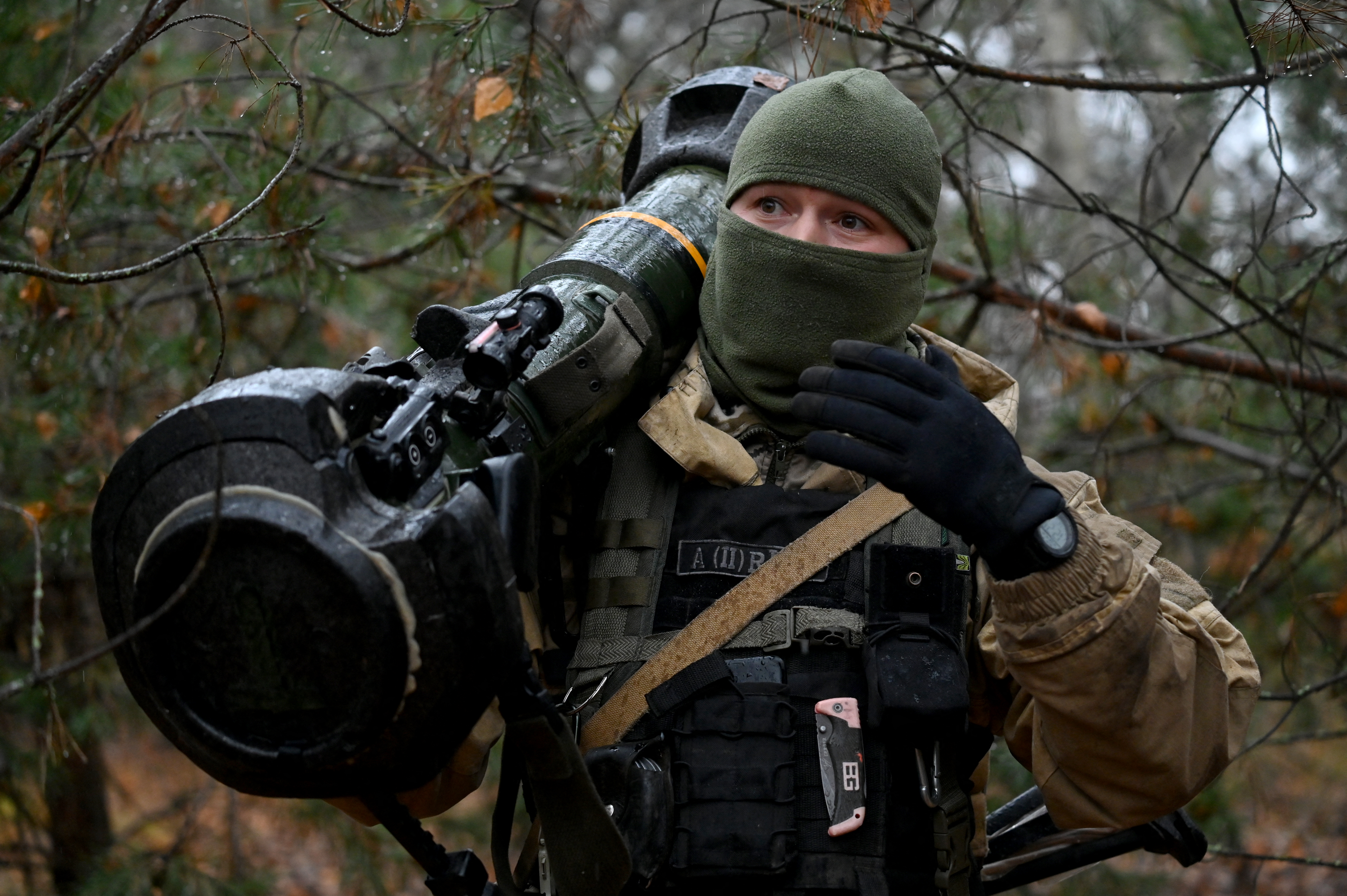 This photograph taken on November 3, 2022 shows a Ukrainian border guard carrying an Anglo-Swedish NLAW anti-tank missile launcher at a fortified position near the Ukrainian border with Russia and with Belarus.