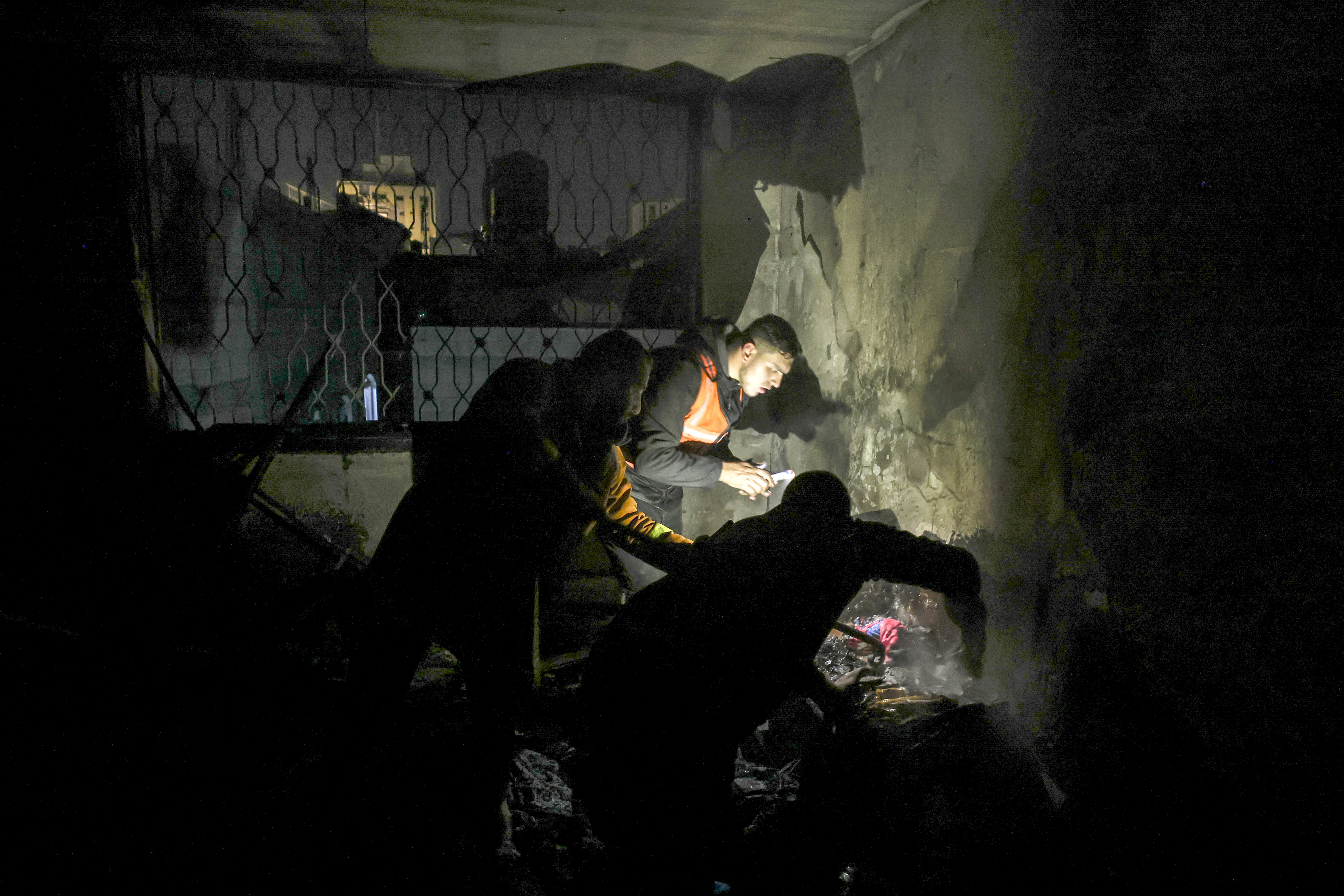 Palestinian firefighters extinguish a fire in Gaza.