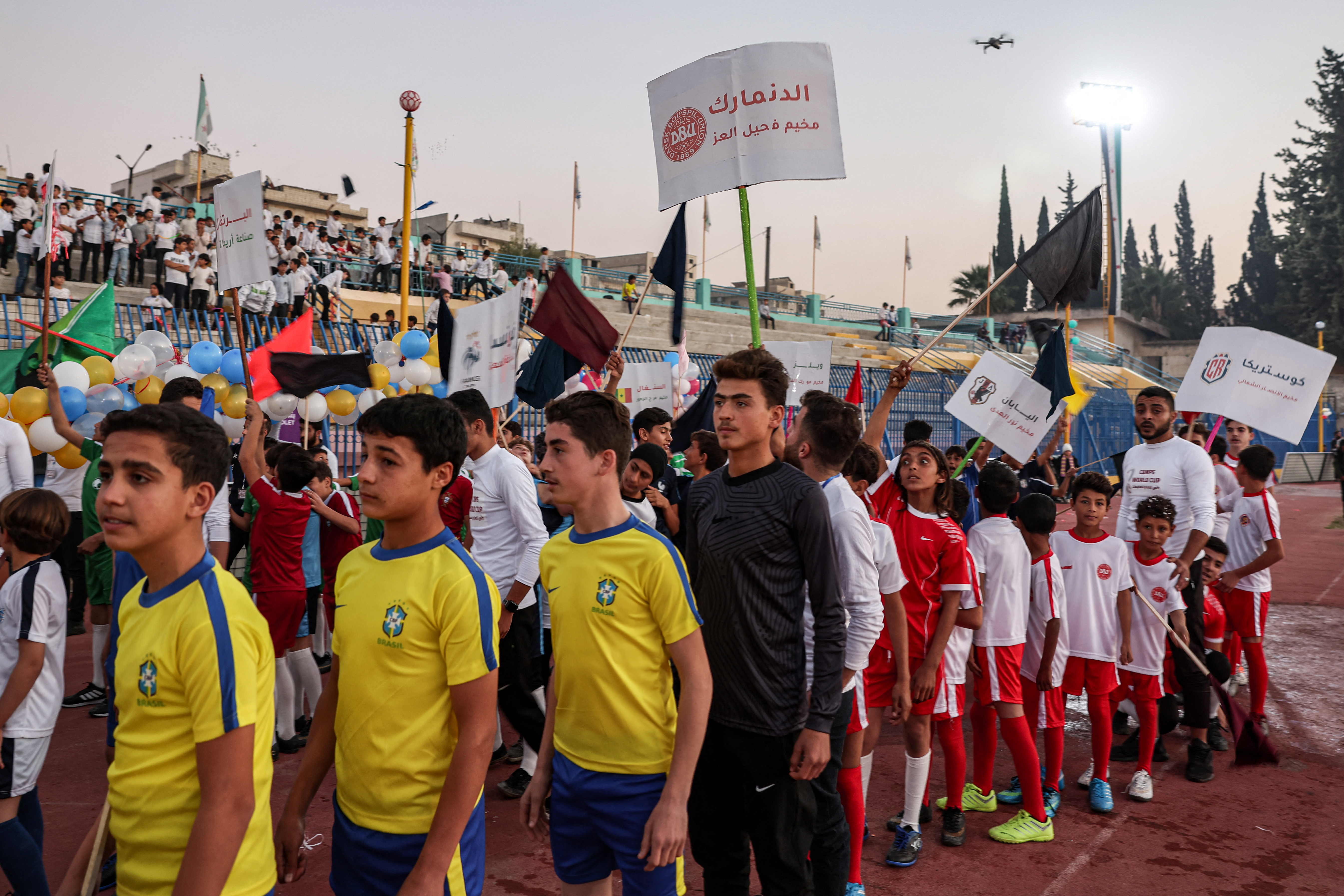 Children wearing the uniforms of national football teams
