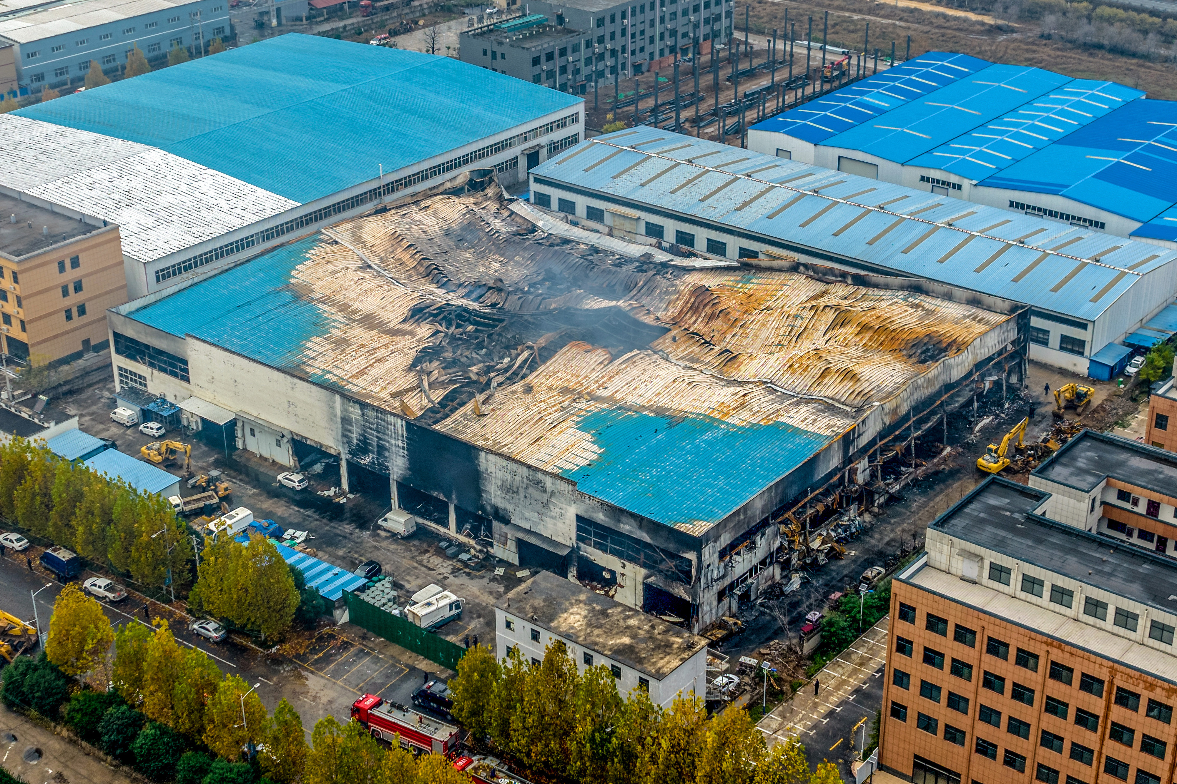An aerial shot saying the melted roof of the factory after the fire was extinguished