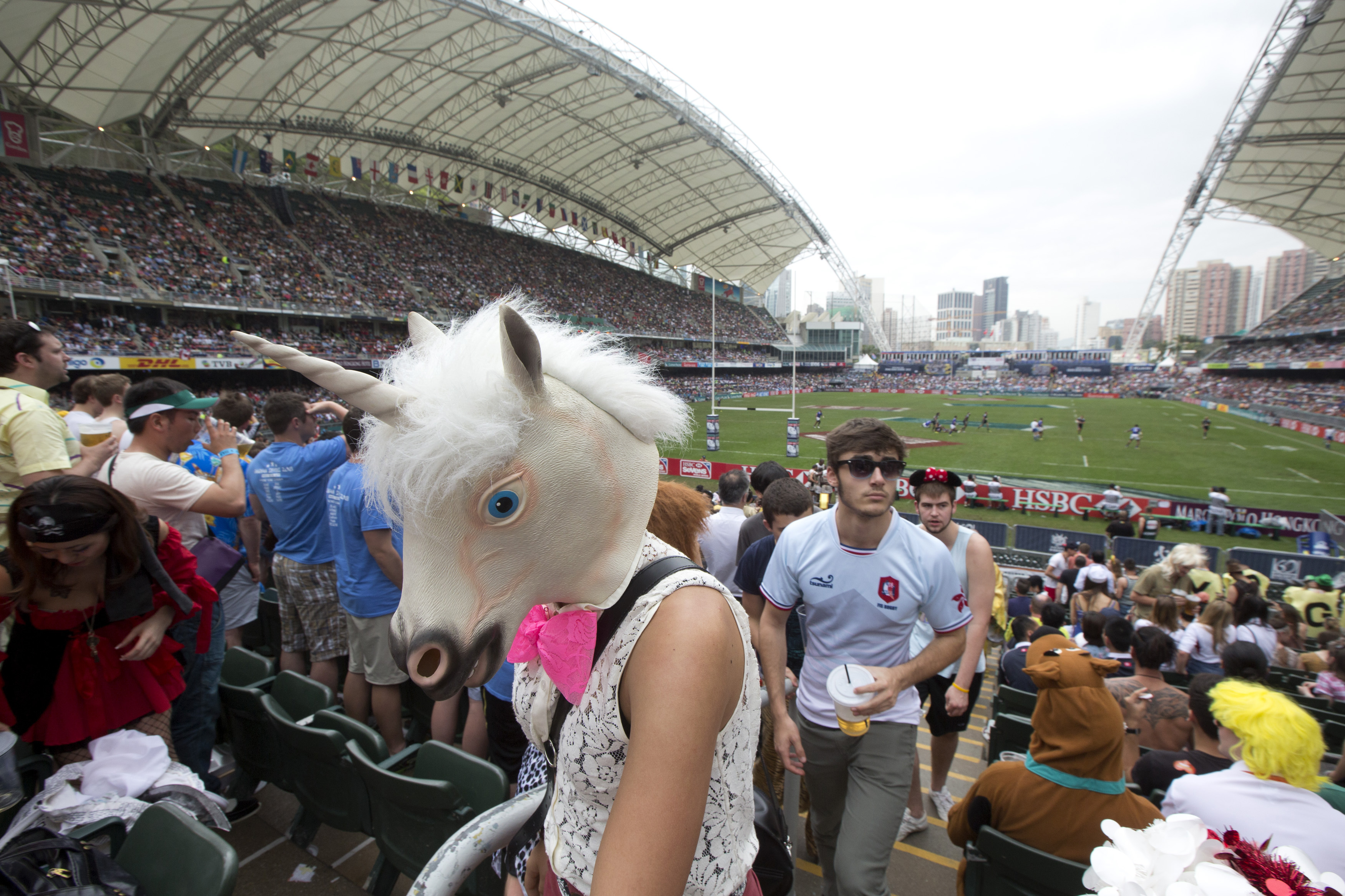 A rugby fan wearing a horse head mask walks in the spectators' stand during the last day of the three-day Hong Kong Rugby Sevens tournament in 2013.
