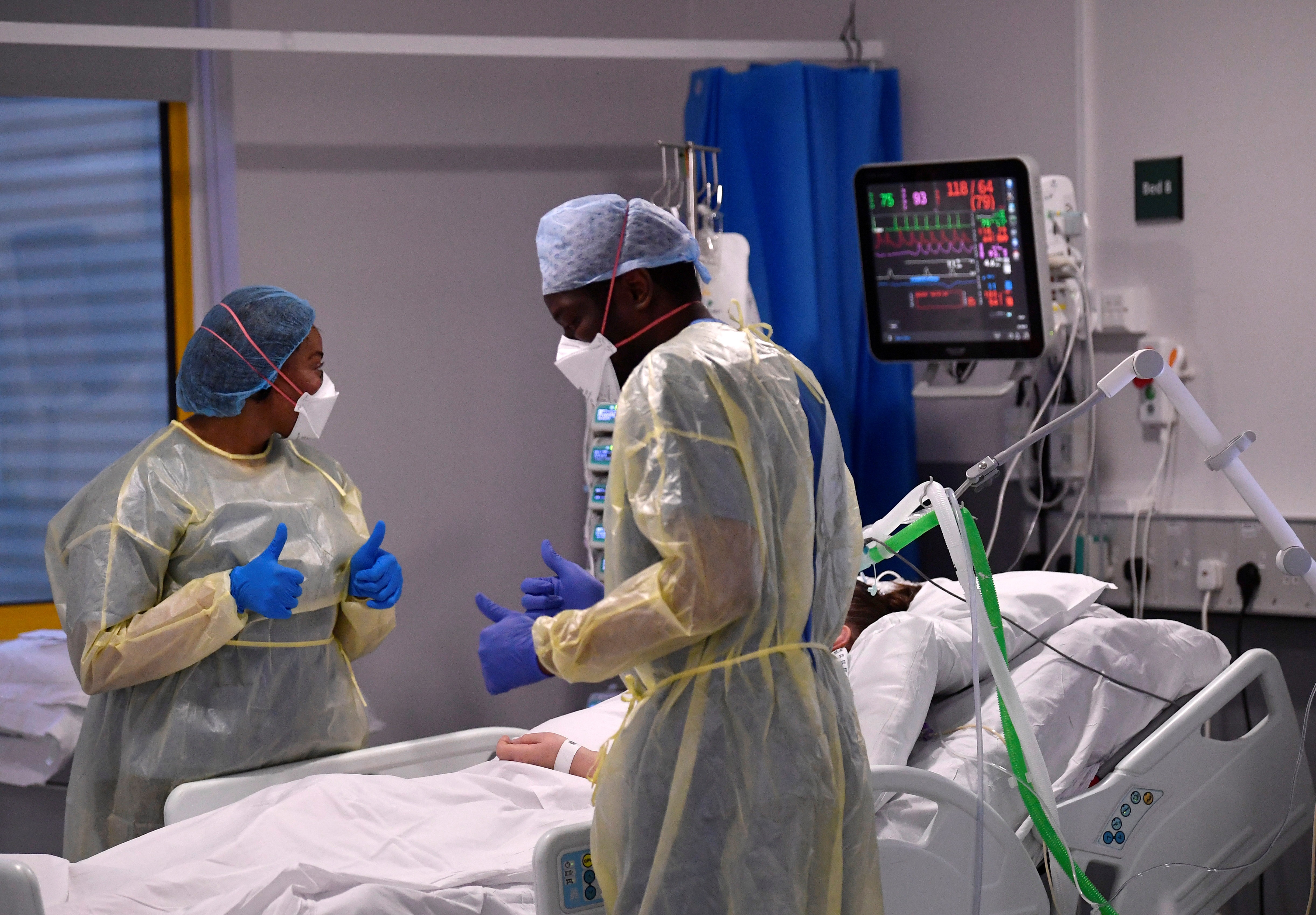 Two nurses around the bed of a COVID-19 patient at an ICU in the British city of Milton Keynes