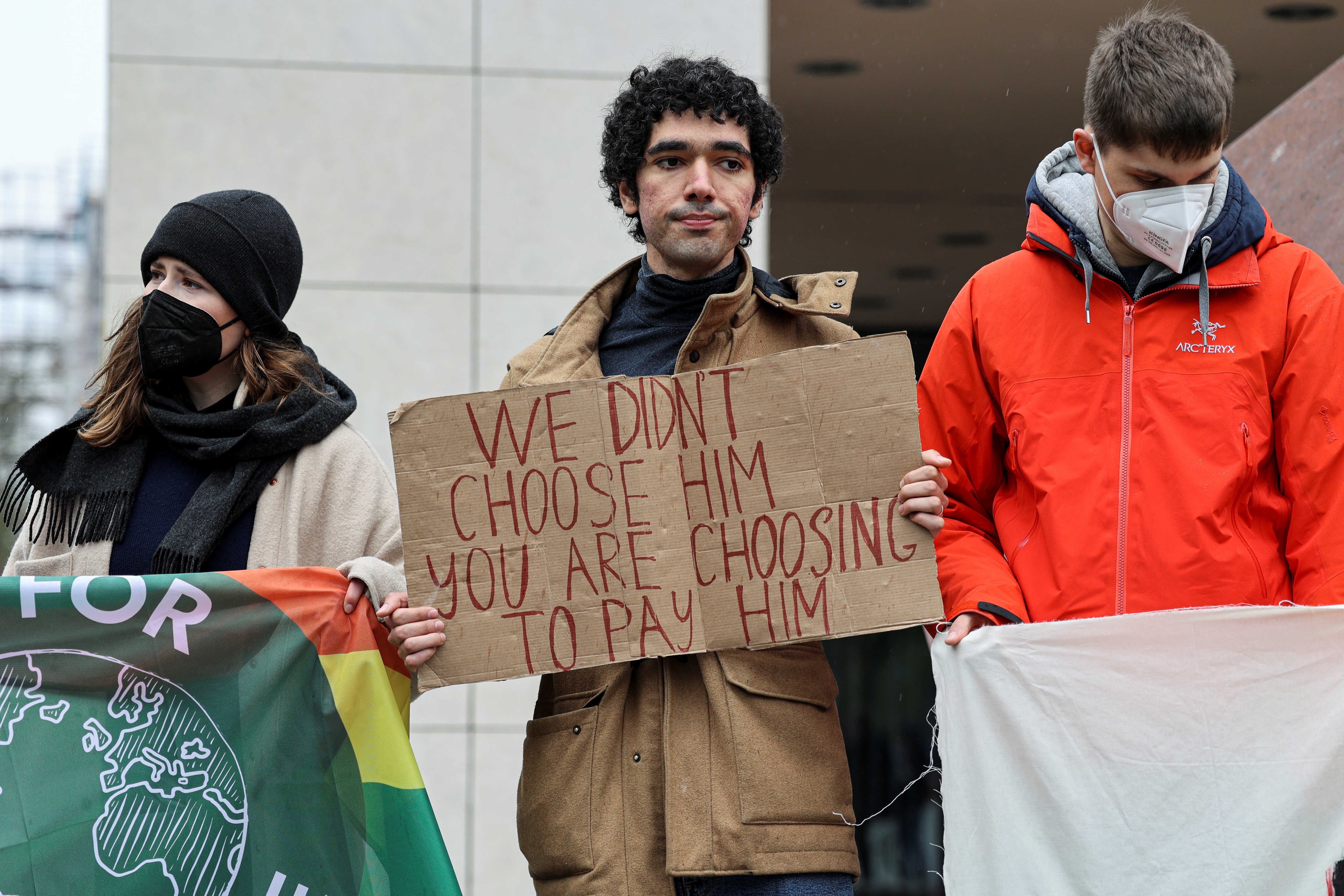 Fridays for Future Russia activist Arshak Makichyan holding a sign looks on during a climate strike of the movement in front of the Social Democratic Party (SPD) headquarters in Berlin, Germany, April 22, 2022. REUTERS/Christian Mang
