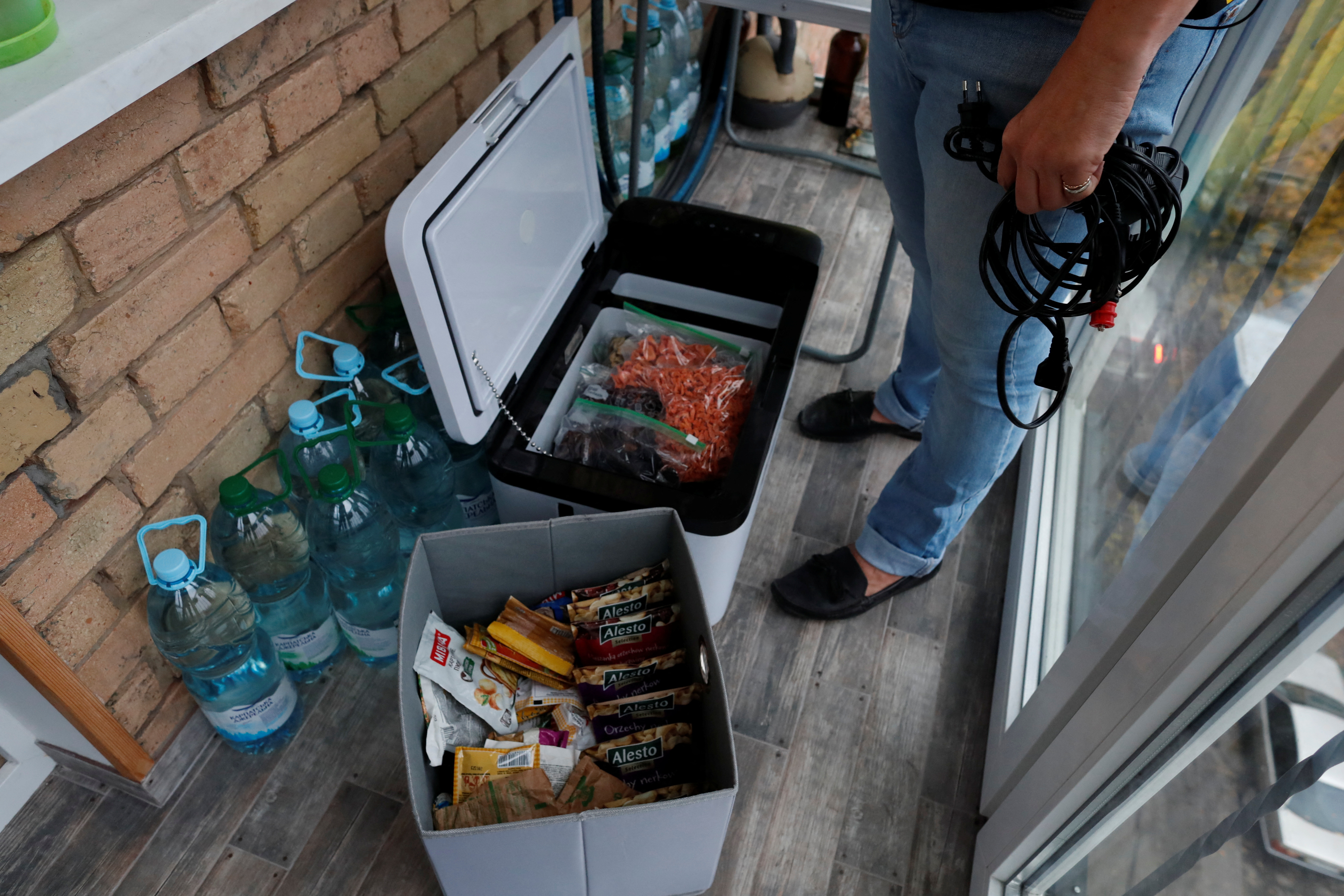 Olena Bastun, a 53 year-old travel enthusiast prepare for power and water cuts.