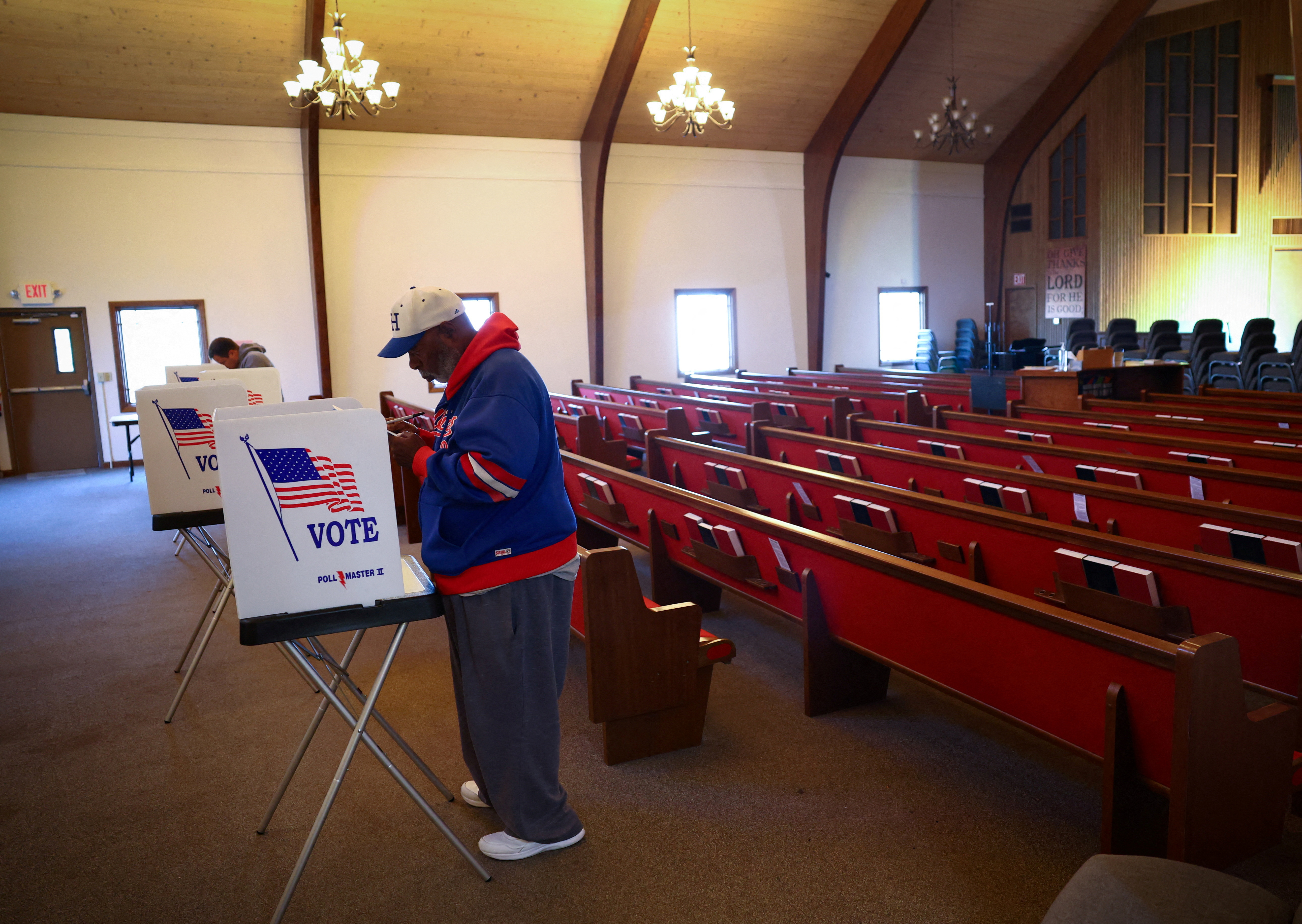Alex Erby fills out his ballot while voting at a polling station.