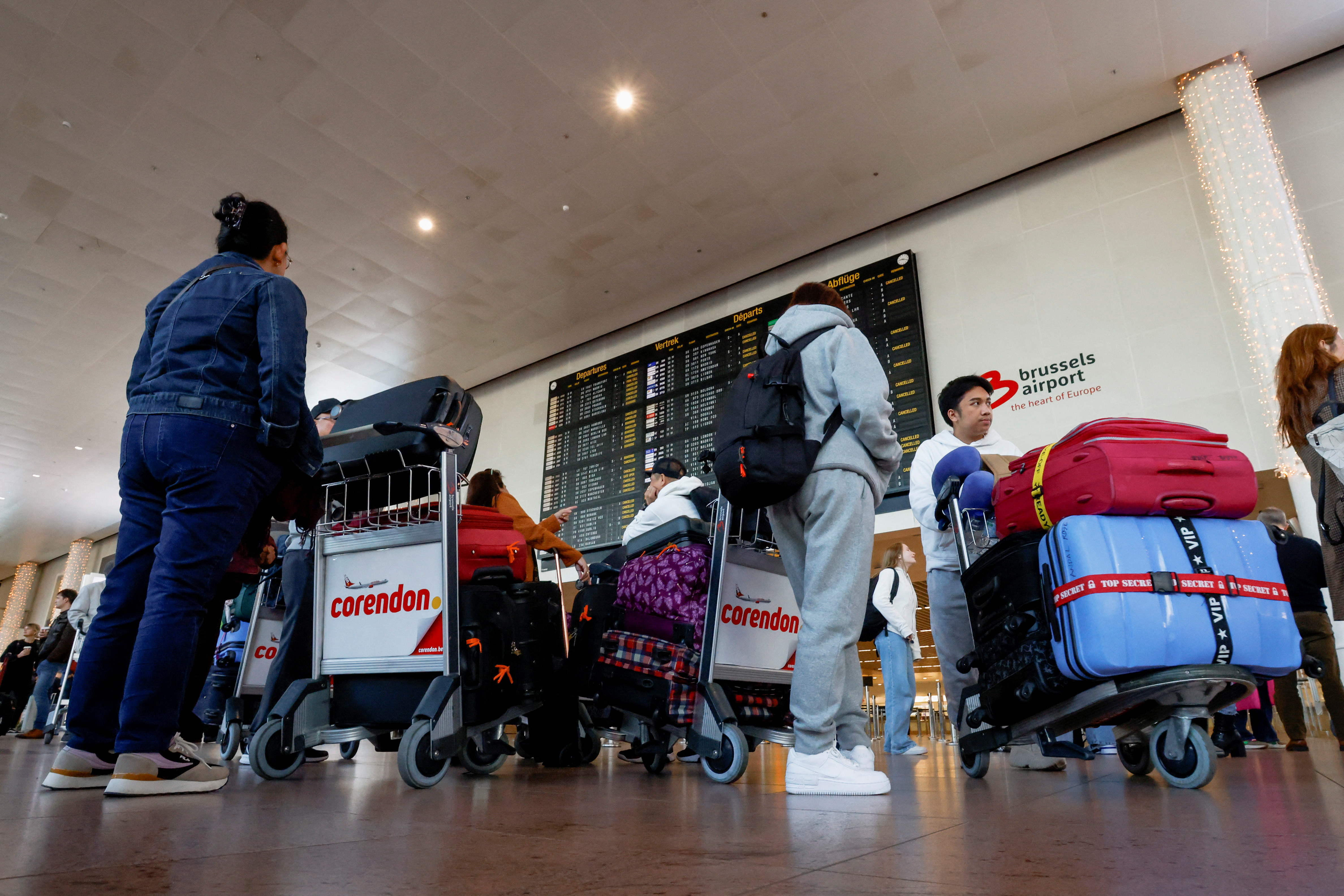 Passengers stand in the main hall at Brussels Airport during a national strike, in Zaventem near Brussels, Belgium