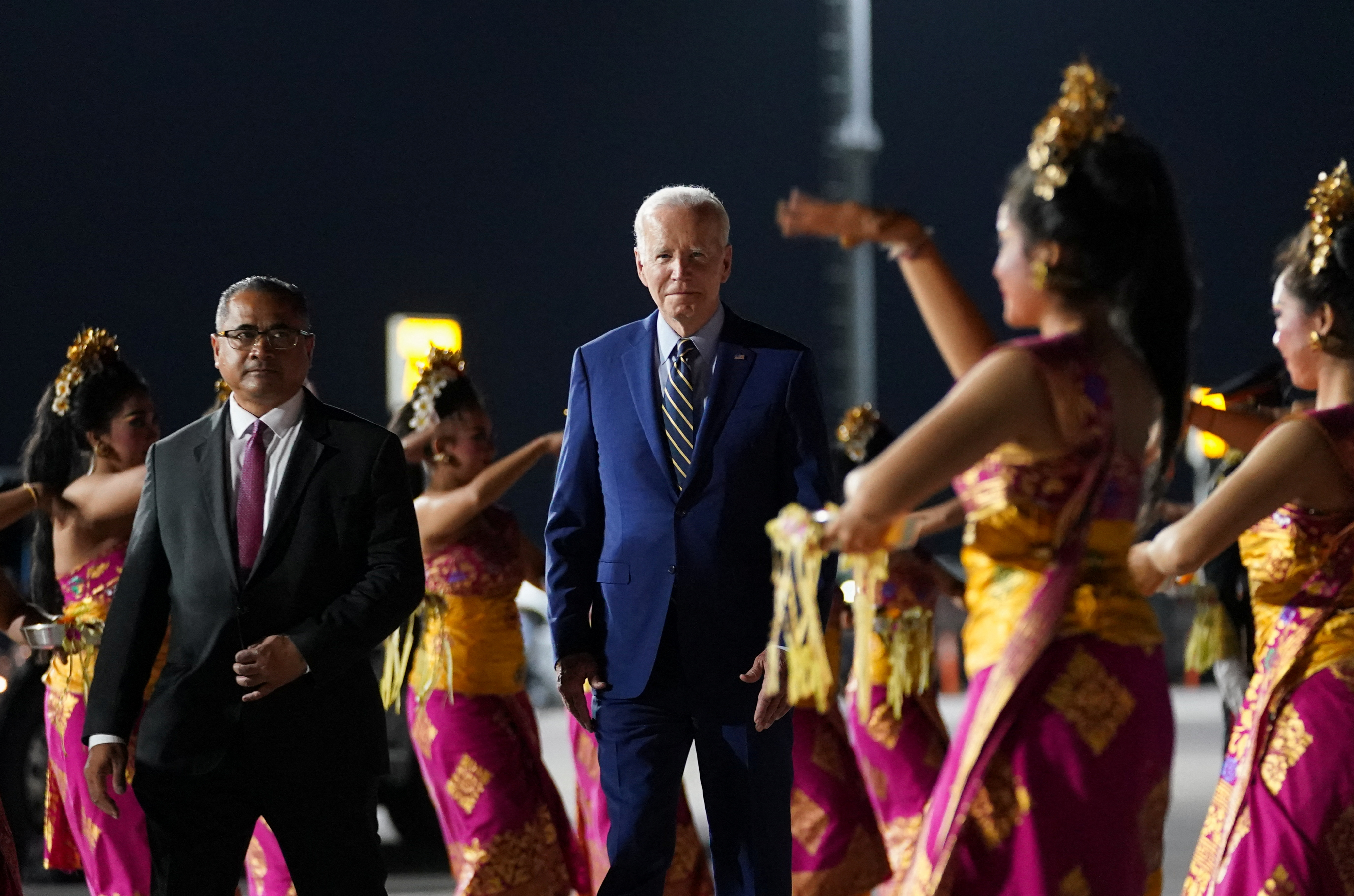Joe Biden at the Bali airport being greeted by Balinese dancers.