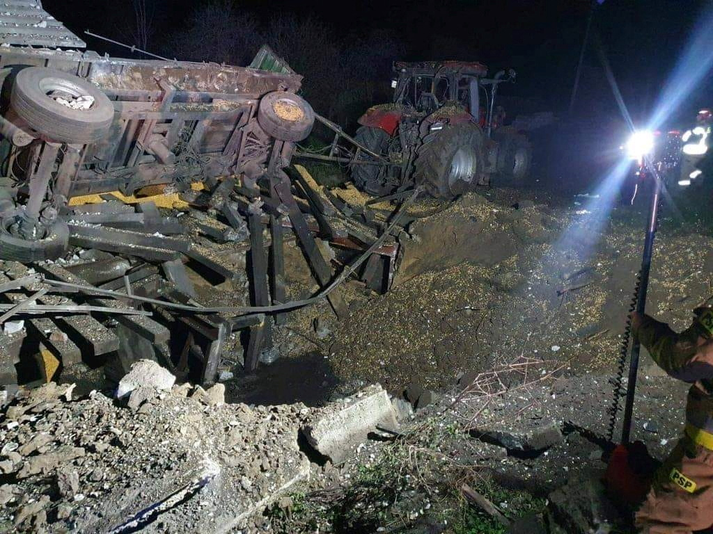 Rubble illuminated by lights after an explosion in a village in eastern Poland