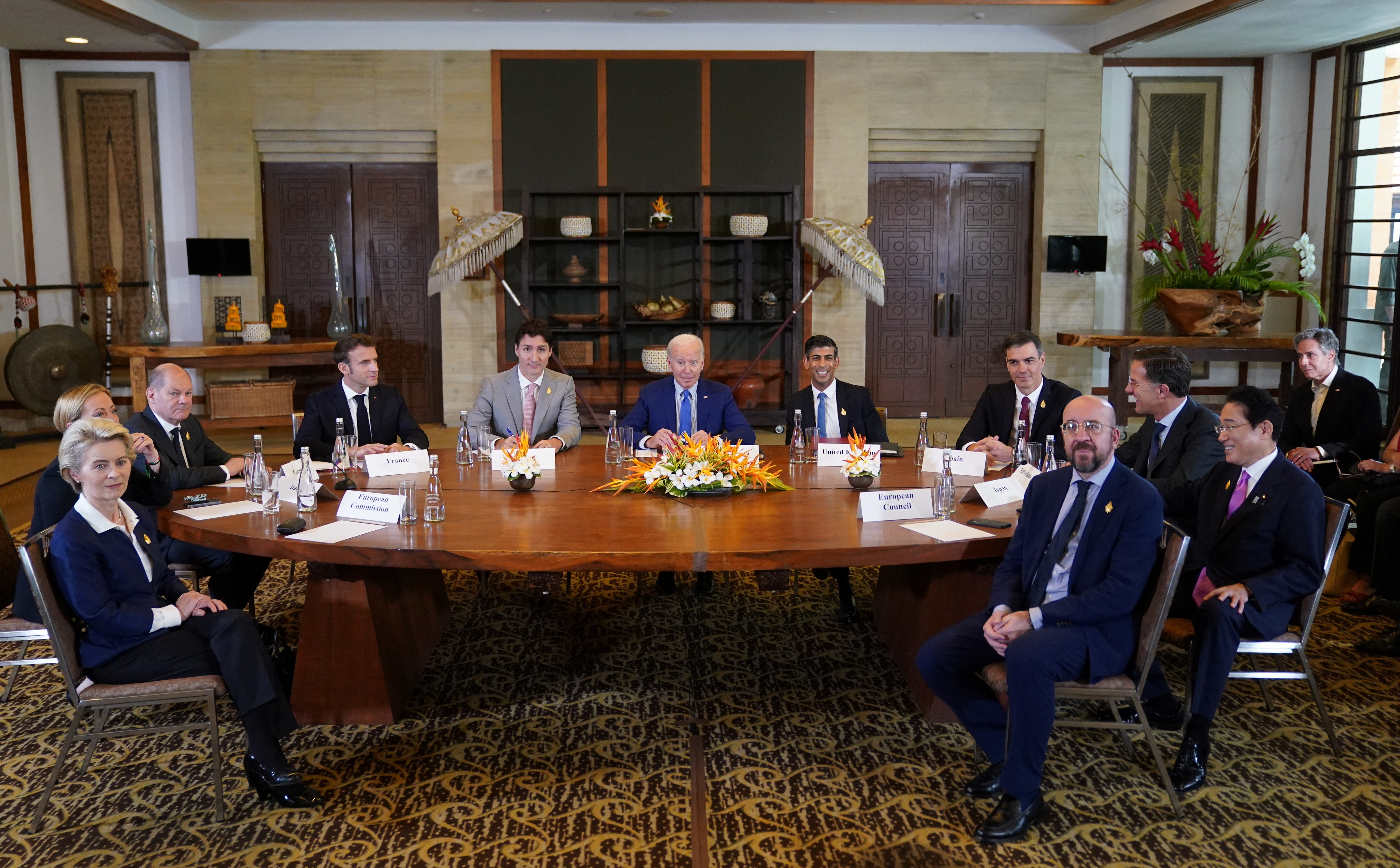 Western leaders with US President Joe Biden at the centre sit around a cionference table at a Bali hotel