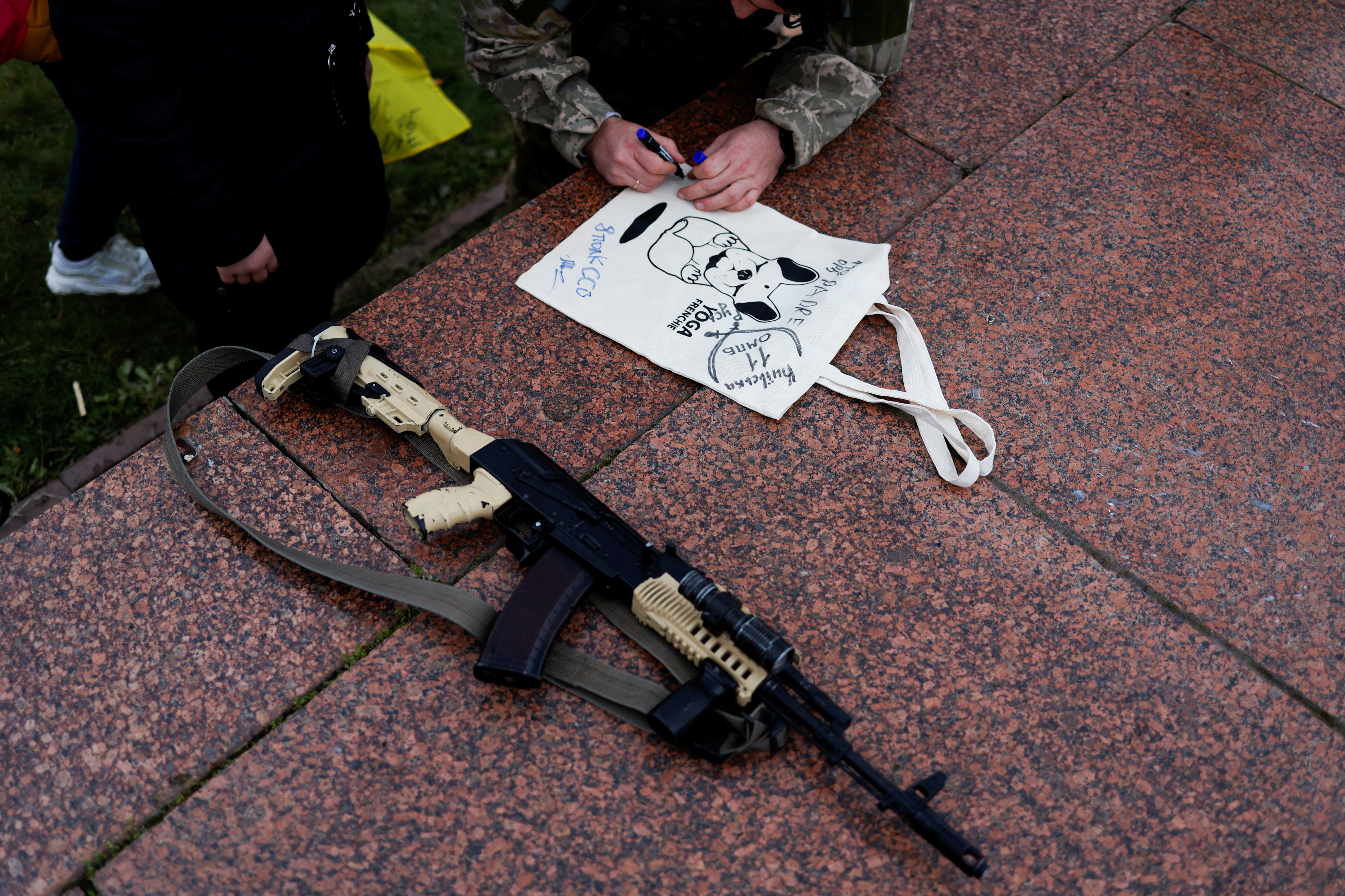 A Ukrainian serviceman gives an autograph