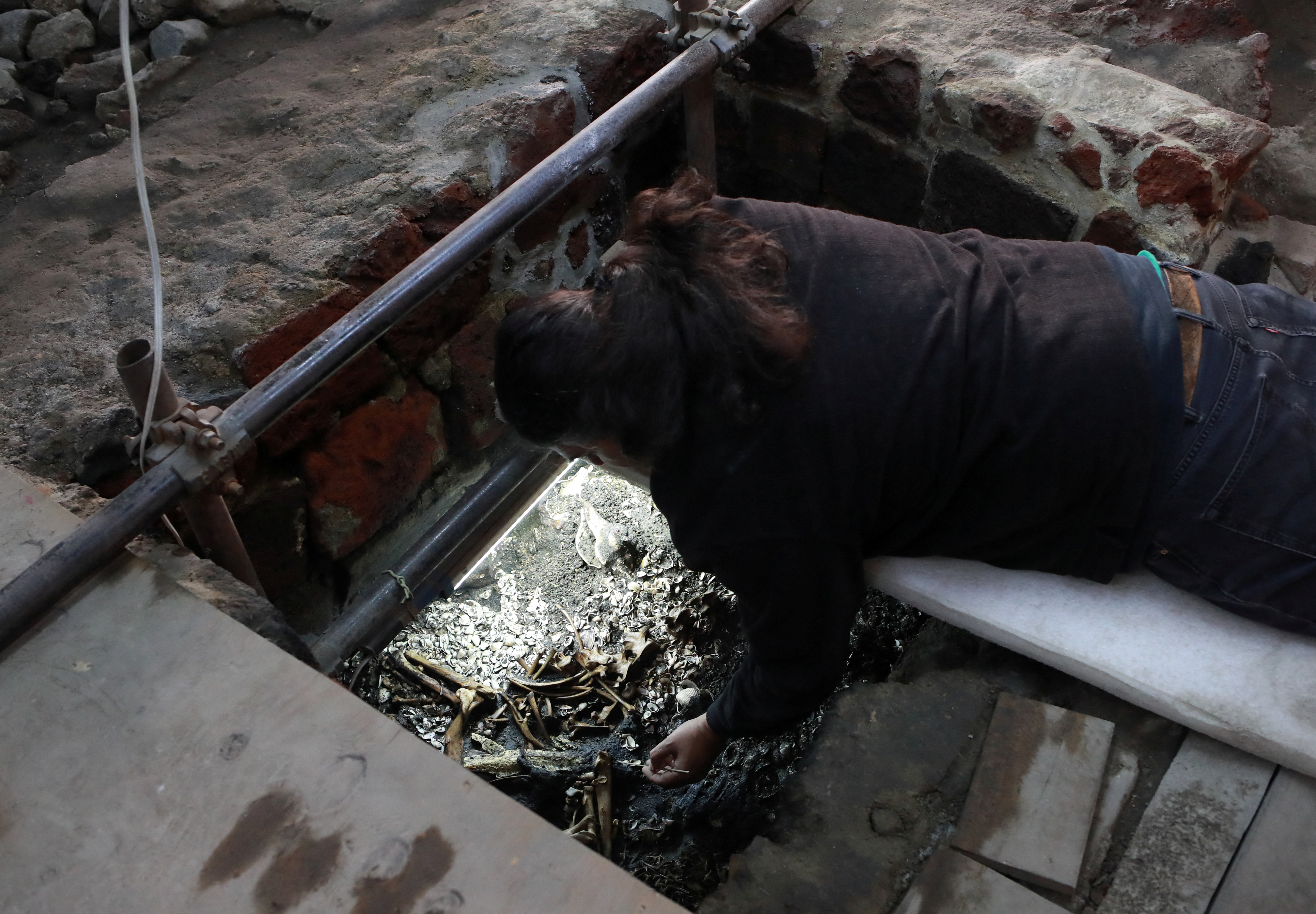 An archeologist excavates a ritual Aztec offering