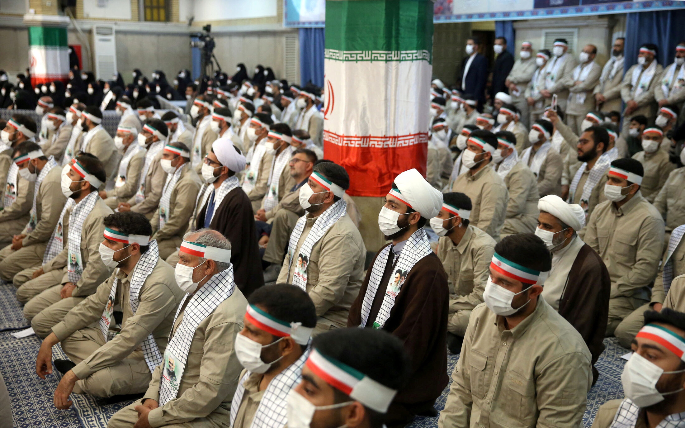 Iranian government supporters listening in a hall