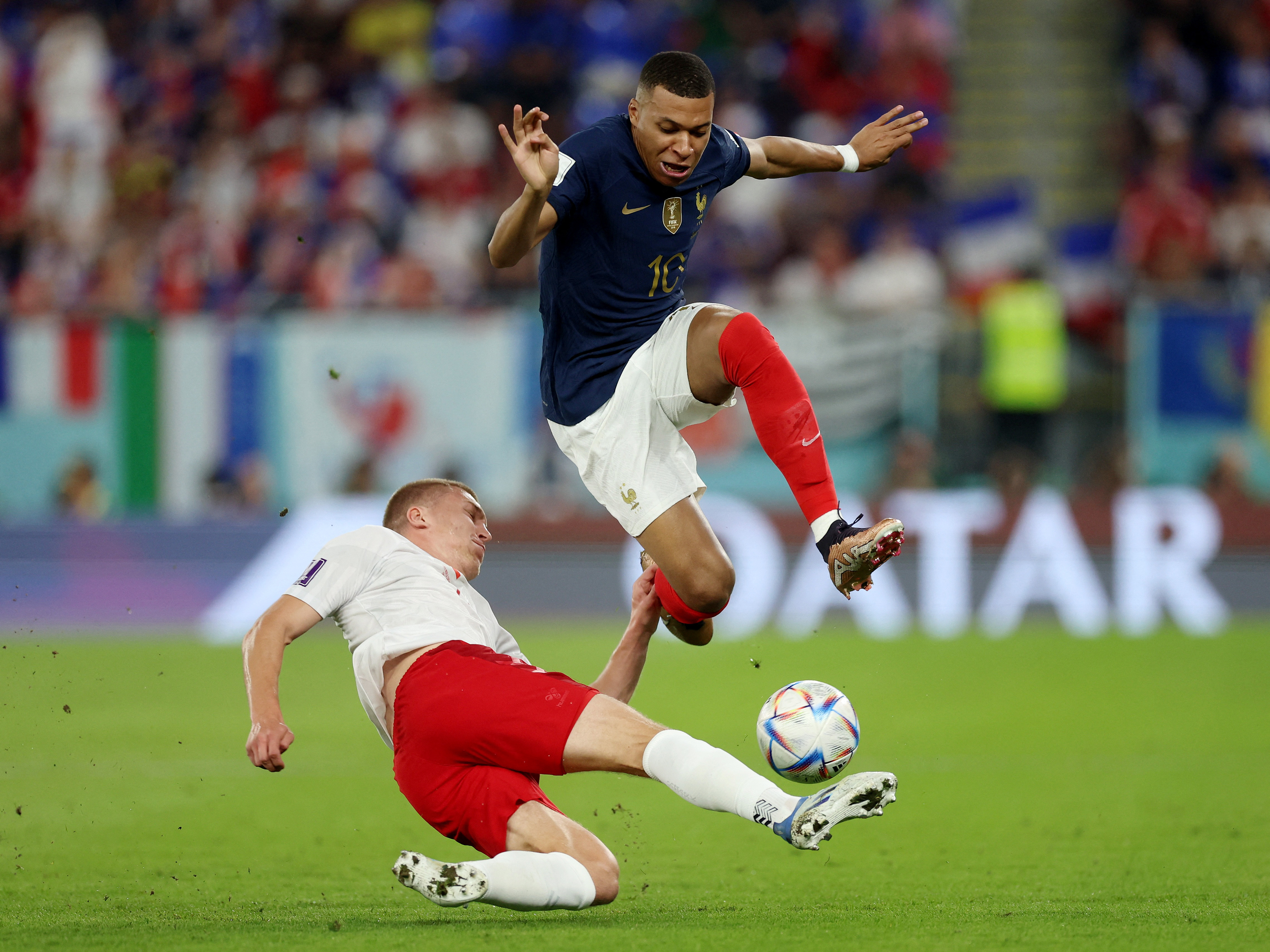 Denmark's Rasmus Kristensen in action with France's Kylian Mbappe