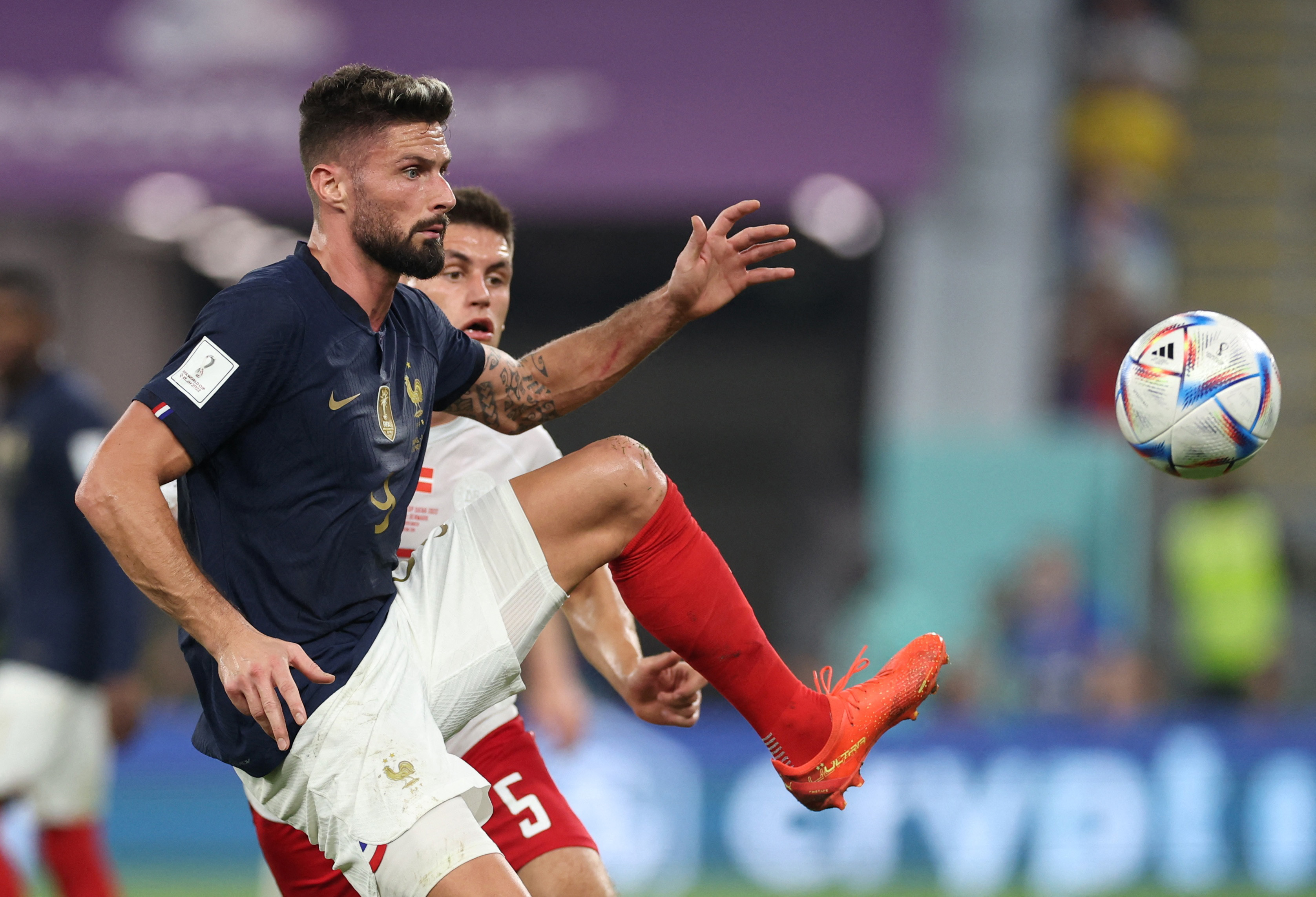 France's Olivier Giroud in action with Denmark's Joakim Mahle.