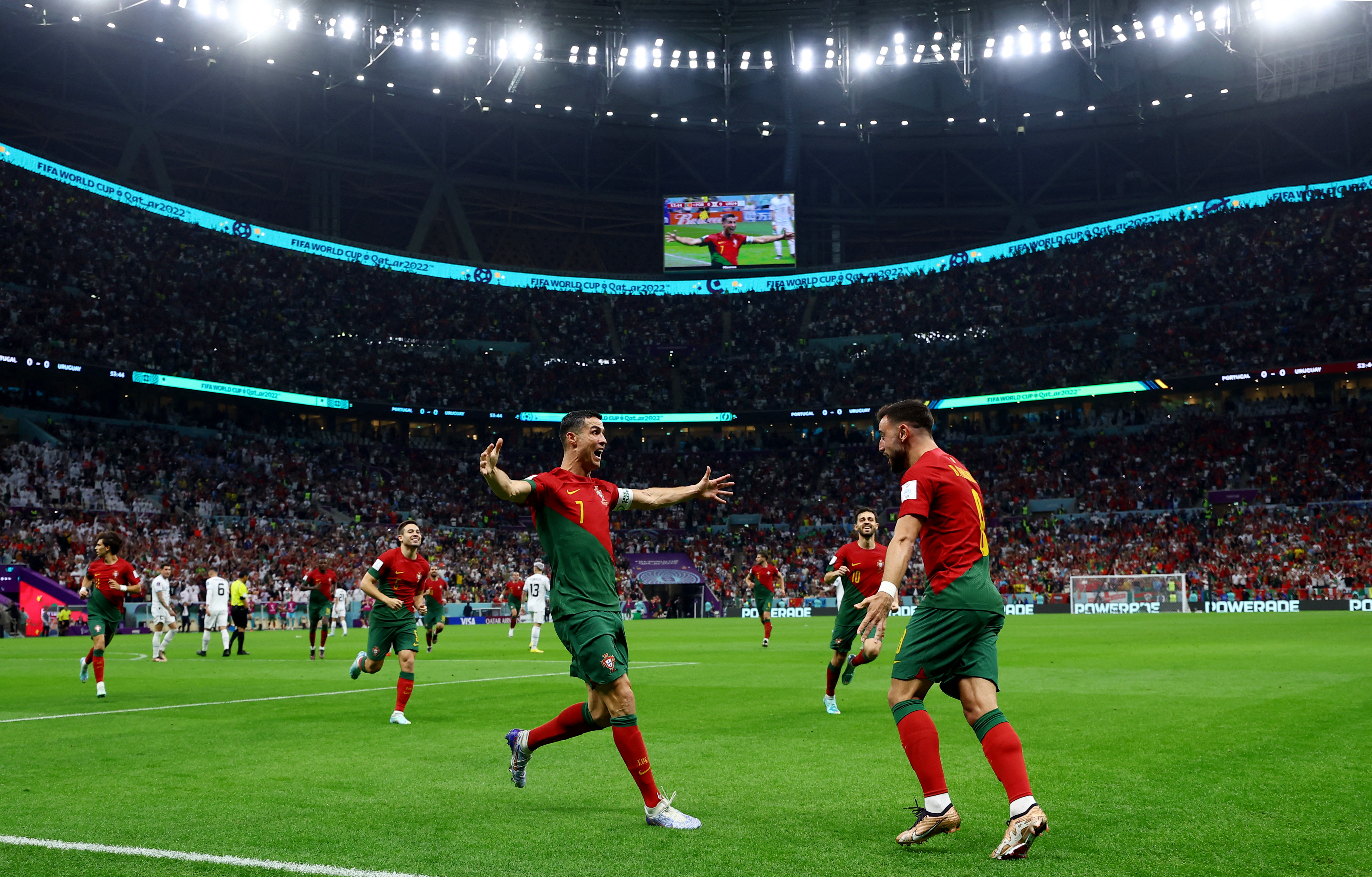 Portugal's Cristiano Ronaldo celebrates scoring their first goal with Bruno Fernandes.