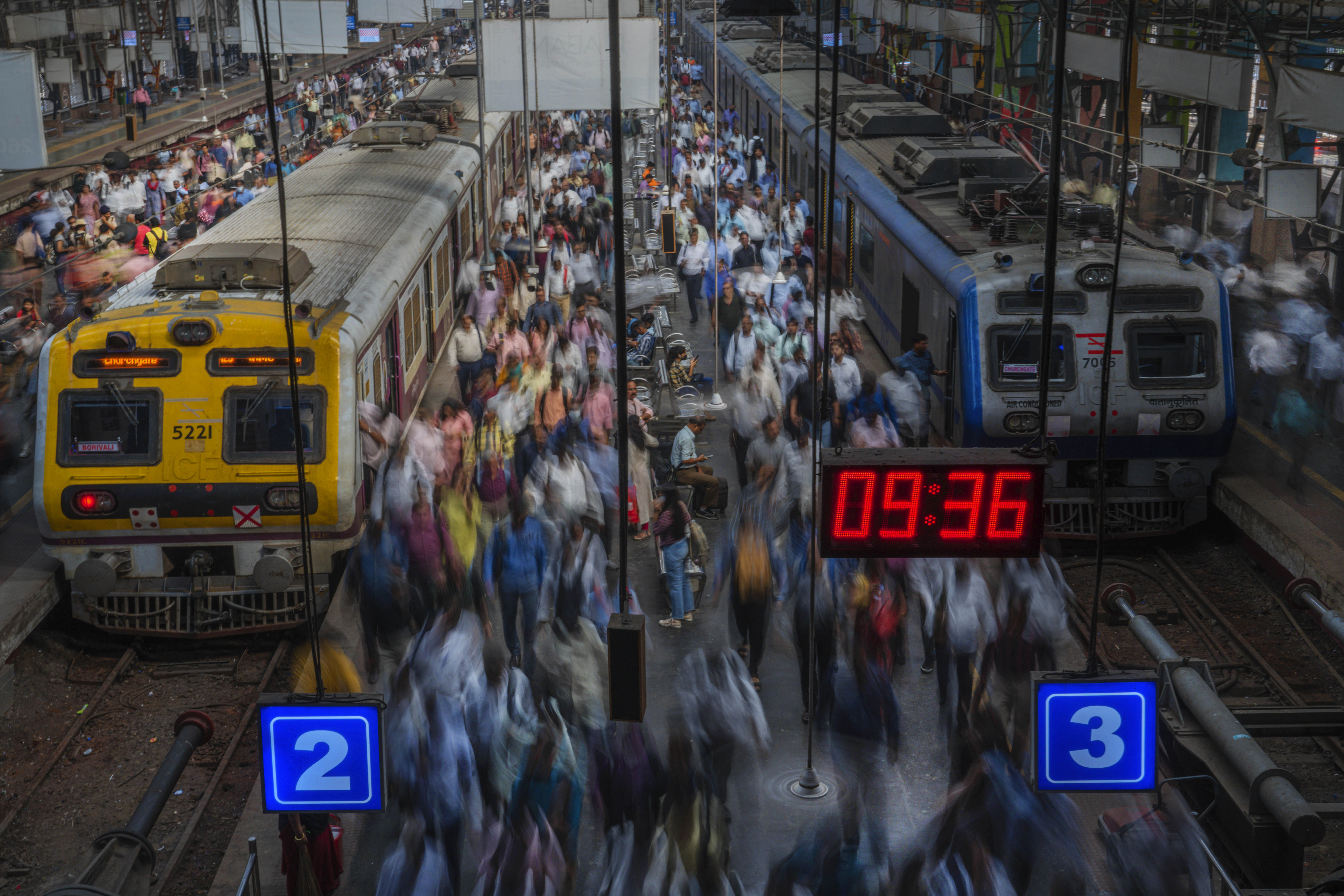 Indian commuters get off trains at the Church Gate railway station.