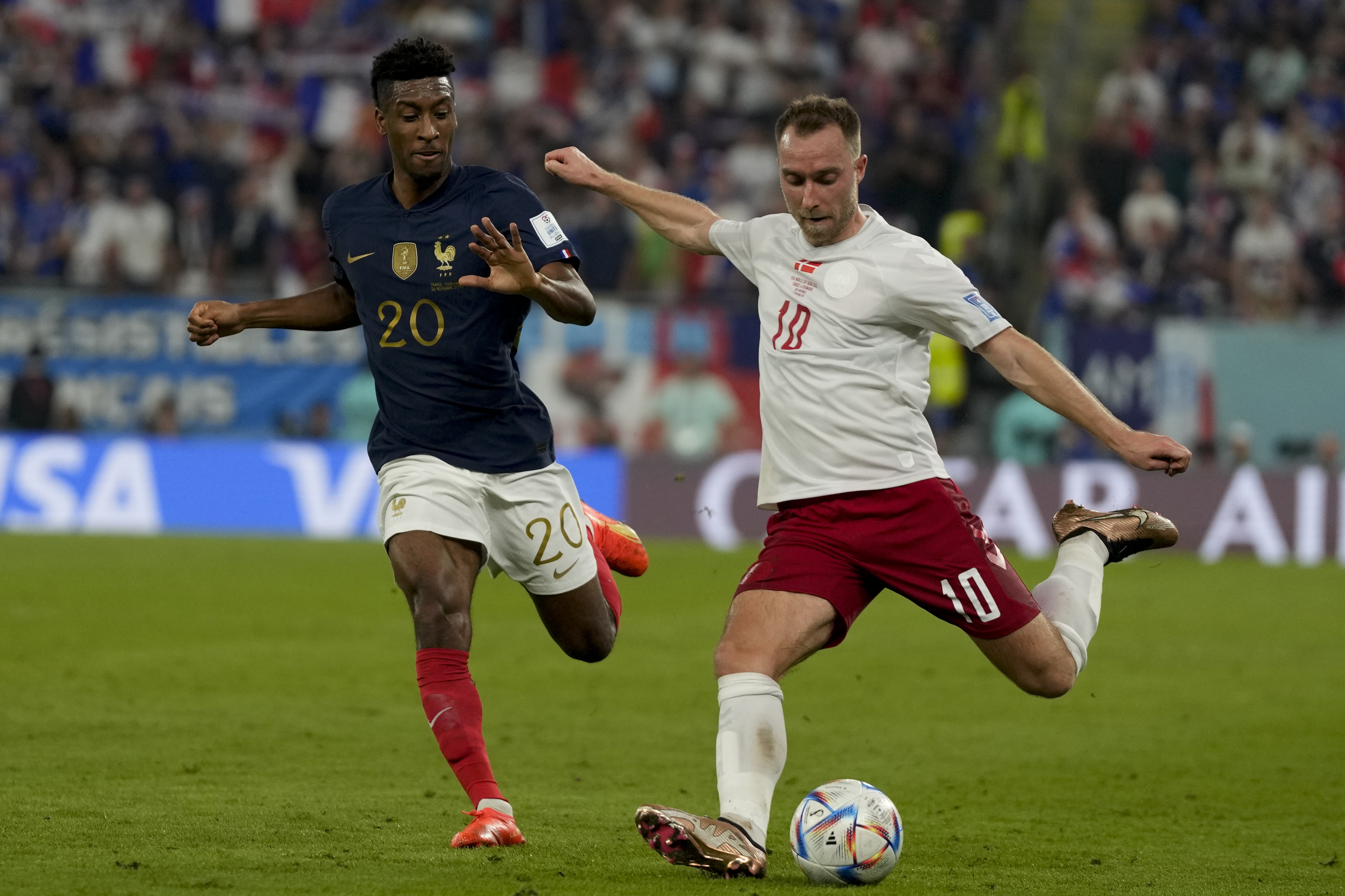 Christian Eriksen, right, and France's Kingsley Coman battle for the ball during the World Cup