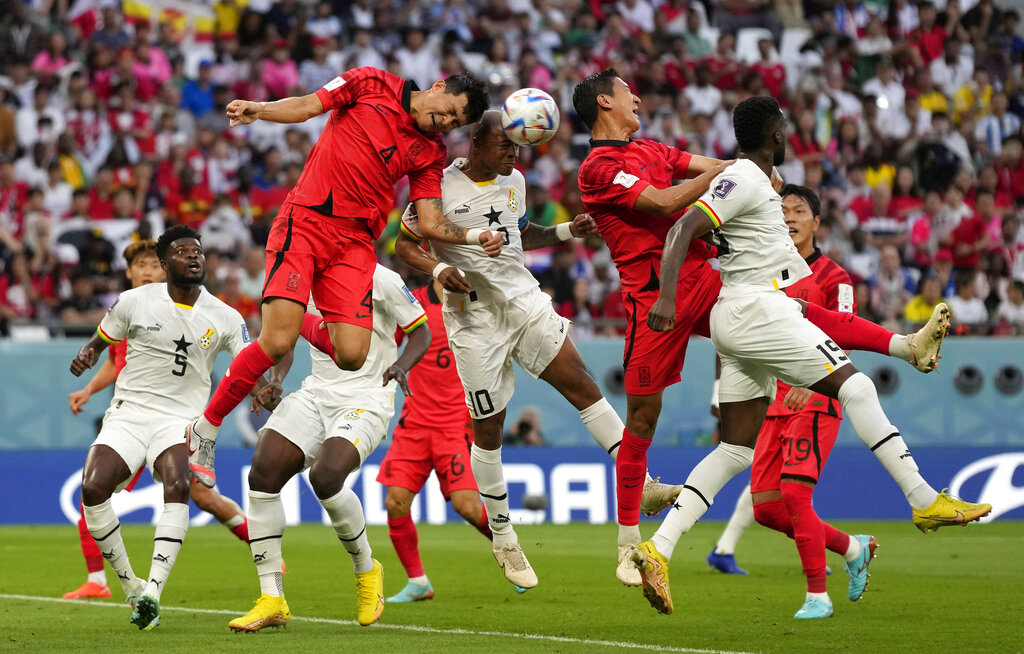 South Korea's Kim Min-jae and Ghana's Andre Ayew jump to head the ball during the World Cup group H football match between South Korea and Ghana.