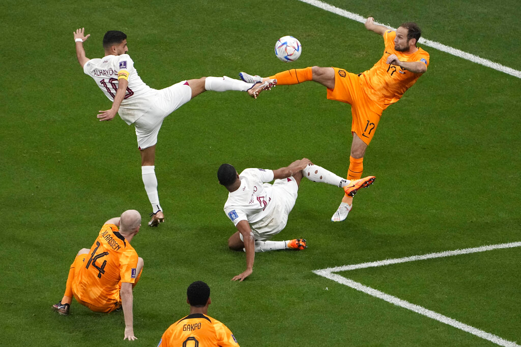 Al-Haydos and Blind almost mirror each other as their feet are outstretched towards each other, touching, with the ball near the centre, above