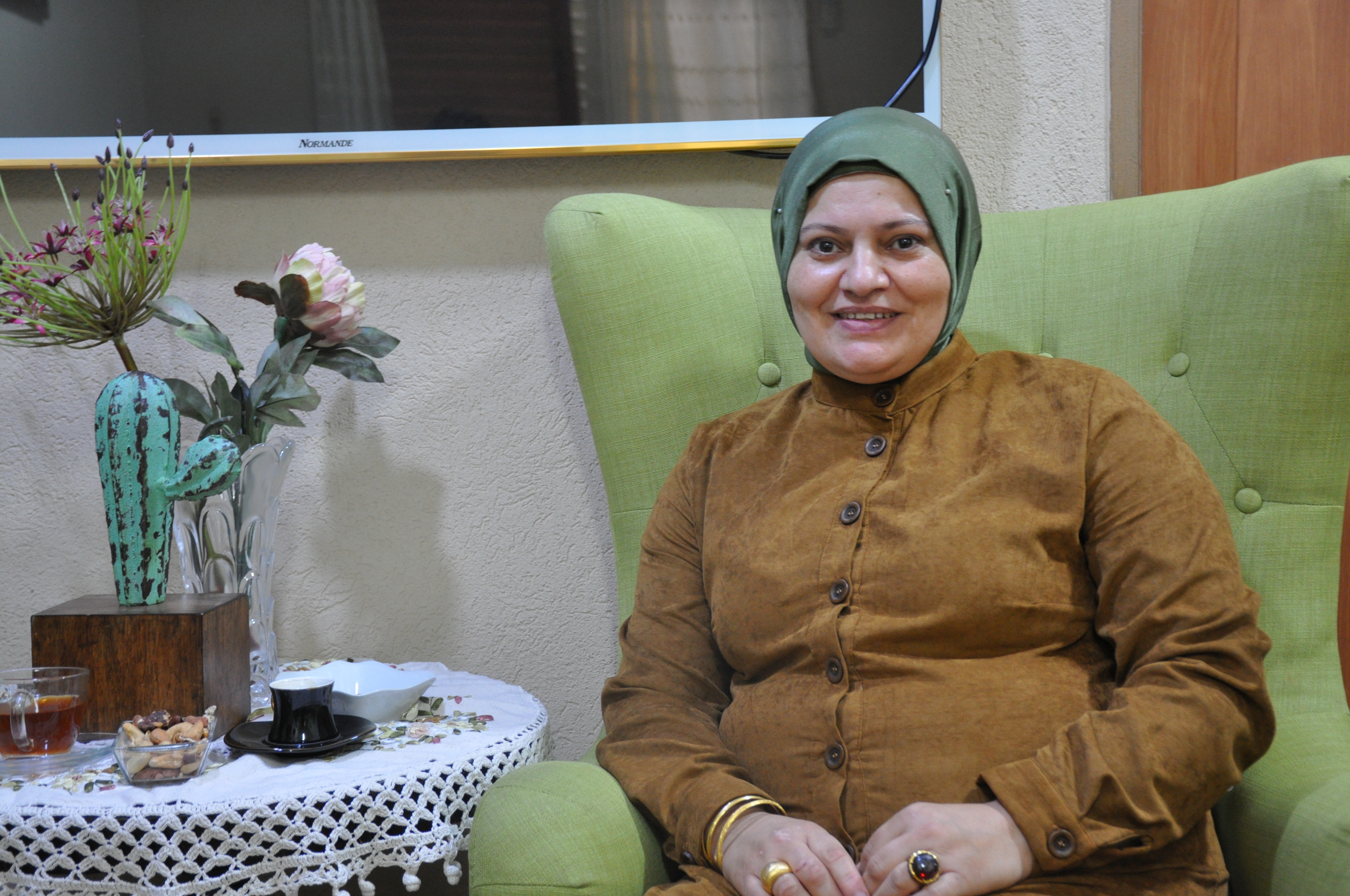 A woman sits on an armchair
